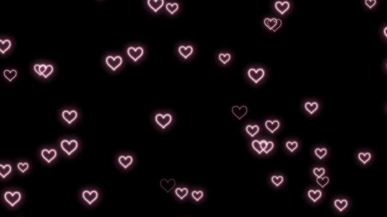 A black background with pink neon hearts floating across the screen - Black heart, pink heart