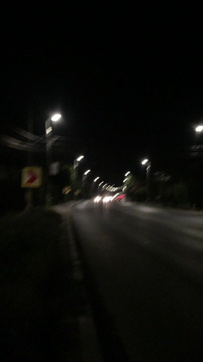 Night time shot of a street with cars and street lights - Blurry