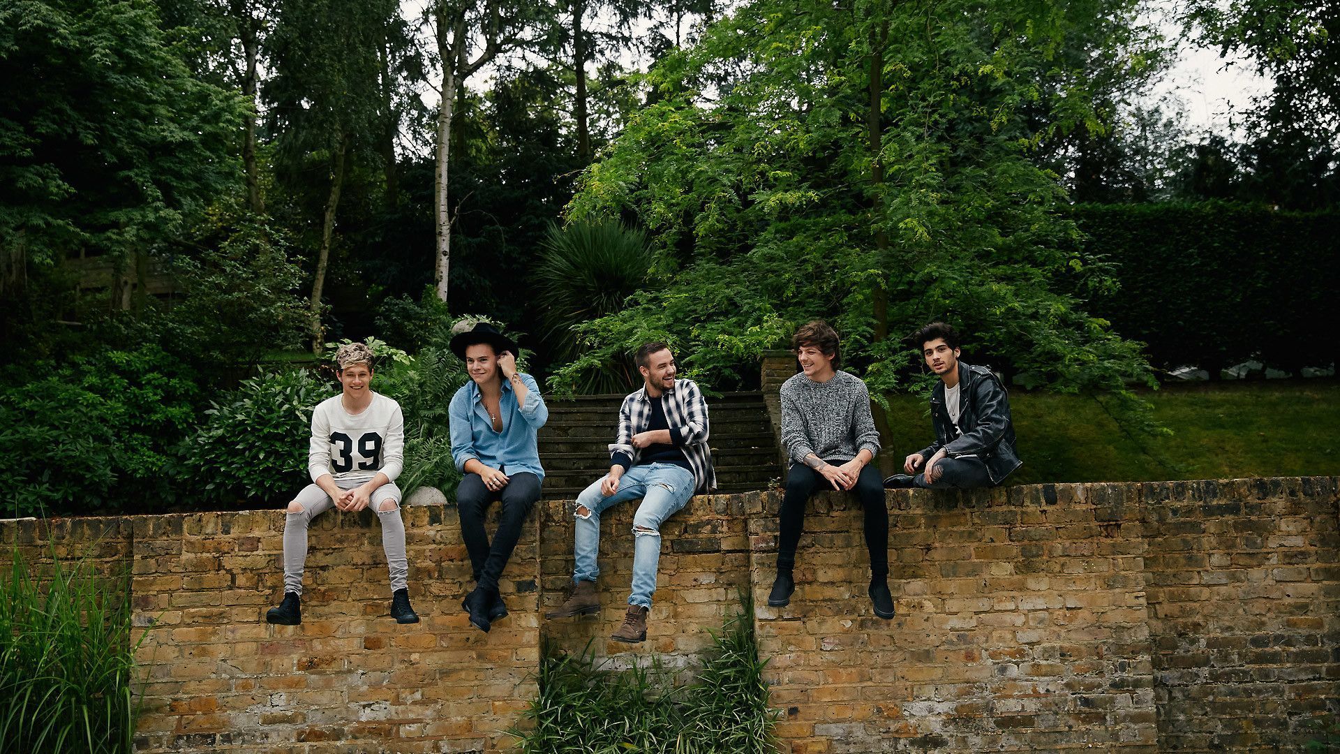 5SOS 5 Second of Summer sitting on a brick wall in the woods - One Direction