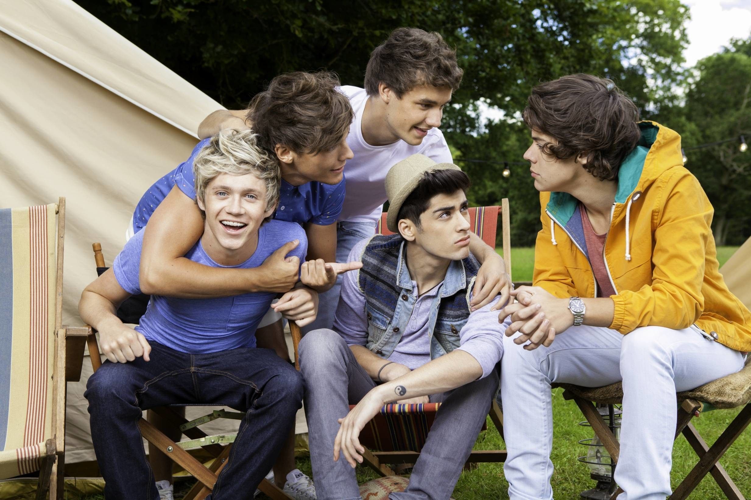 A group of young men sitting in chairs - One Direction