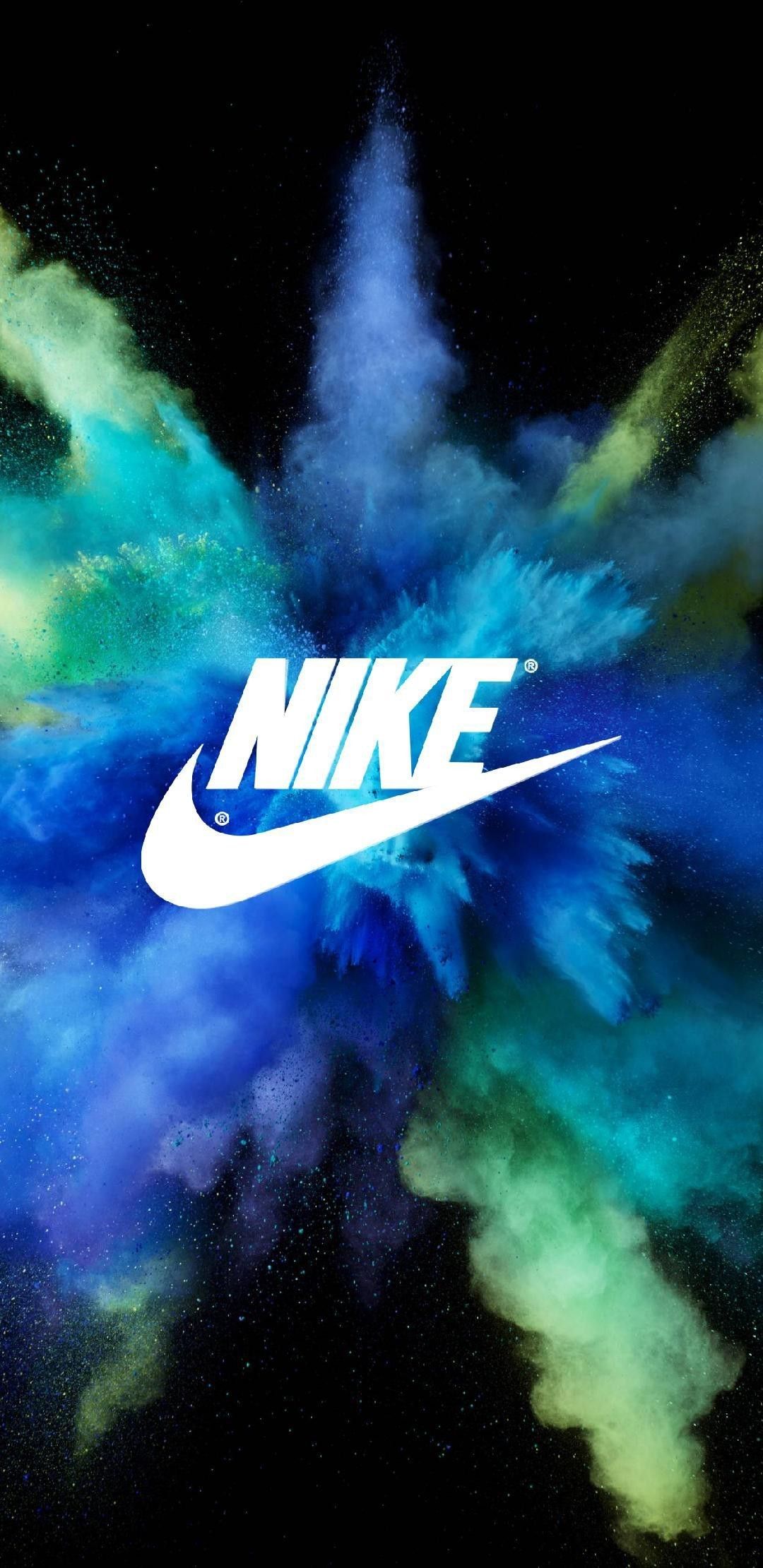 A nike logo is in the middle of colorful powder - Nike
