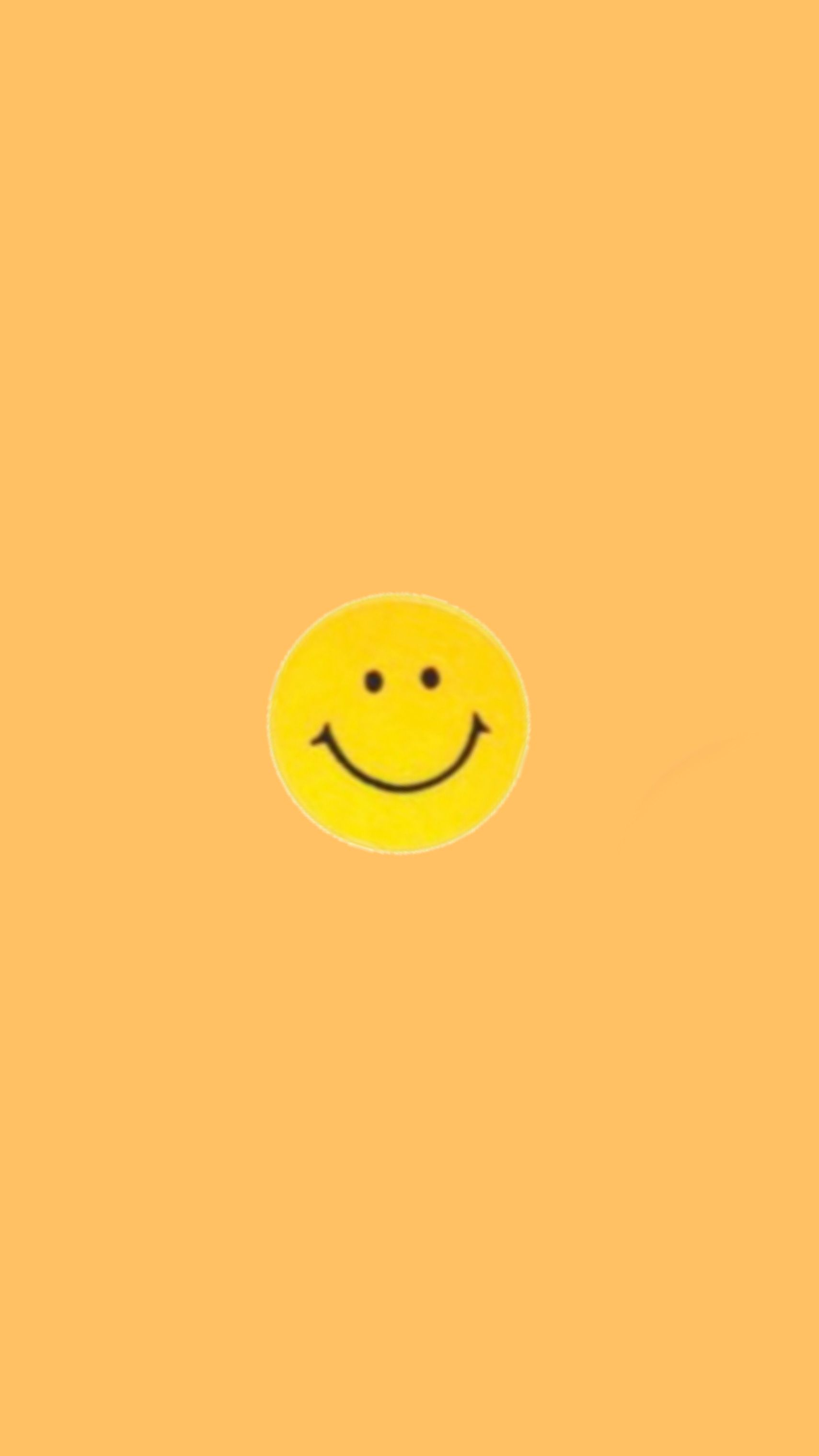A yellow background with an image of the smiley face - Smile
