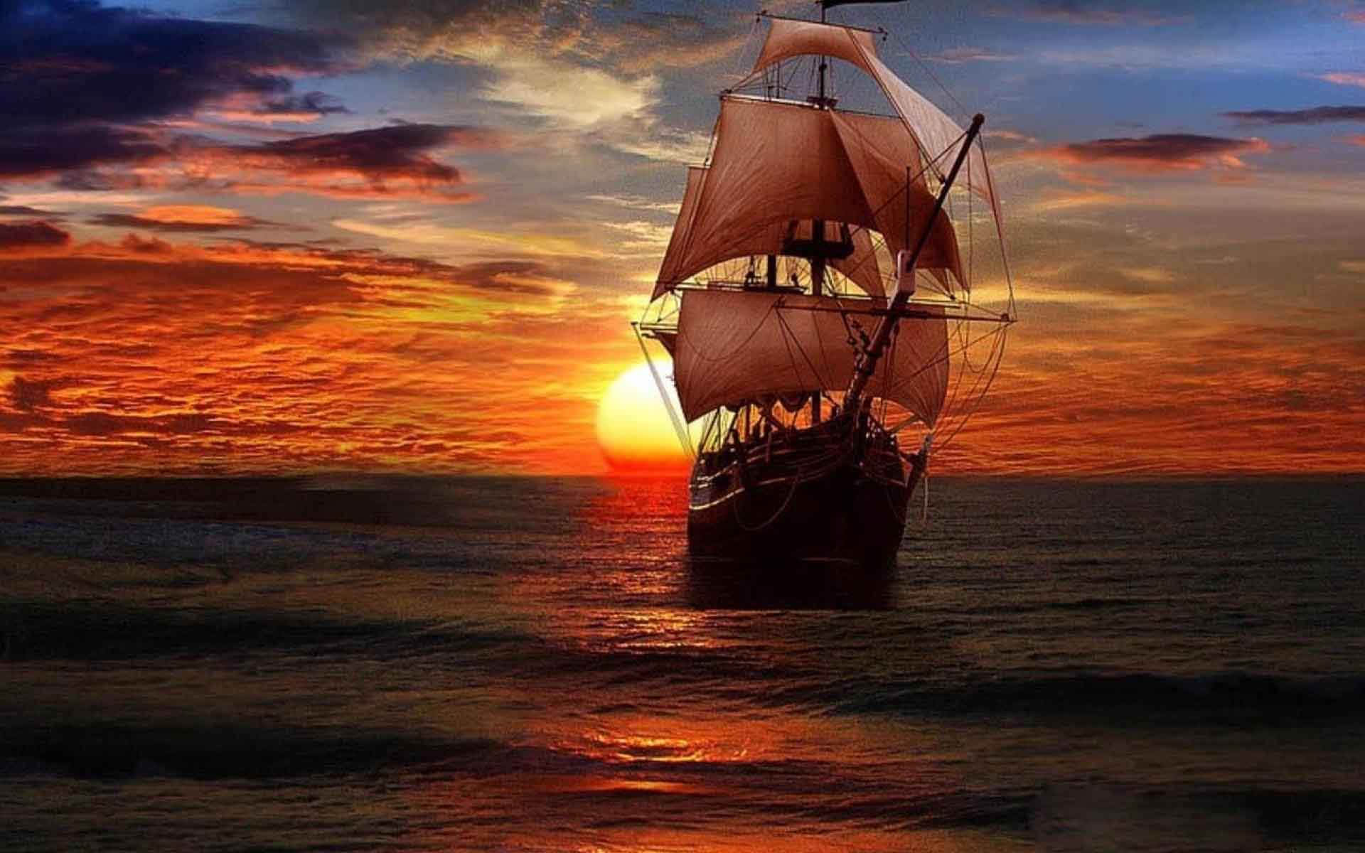 A sailboat in the ocean at sunset - Pirate