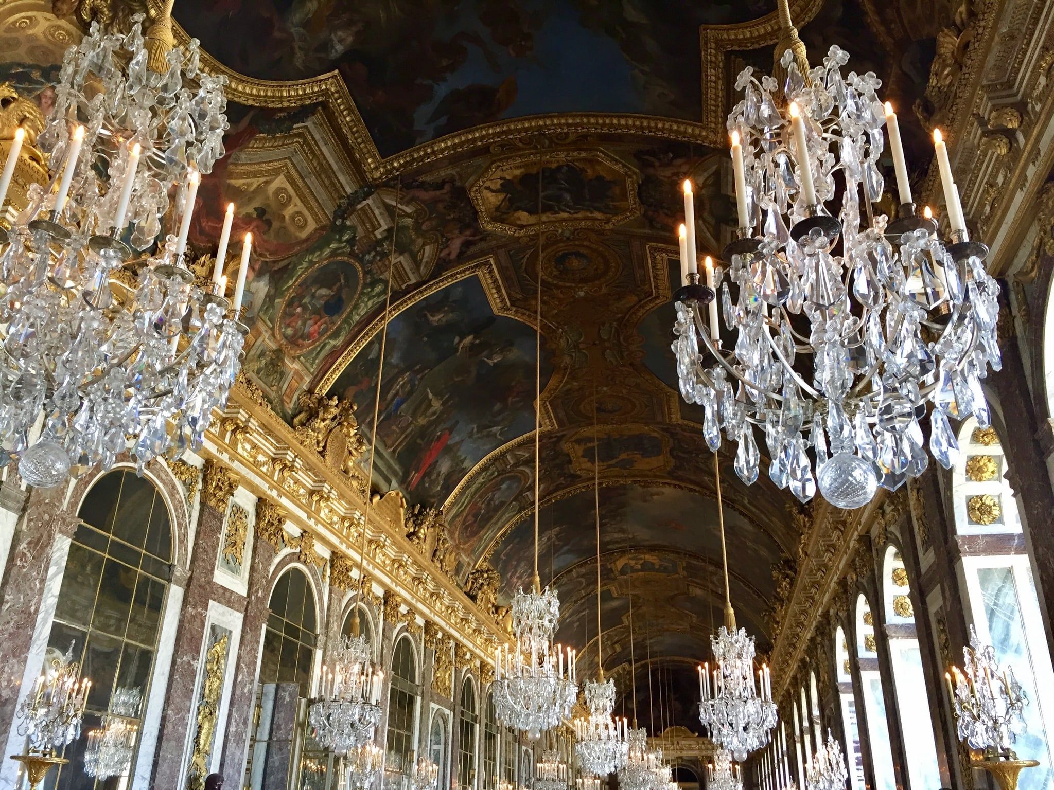 The Hall of Mirrors at Versailles, with its chandeliers and mirrors, was a grand space. - Royalcore