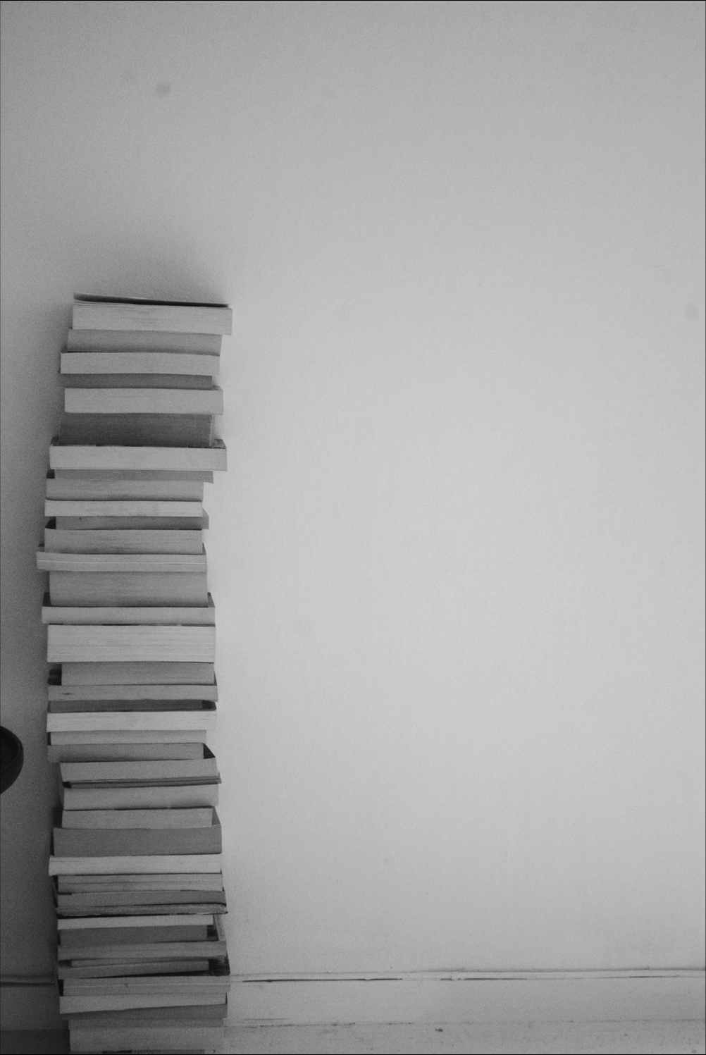 A stack of books sitting on top shelf - Gray
