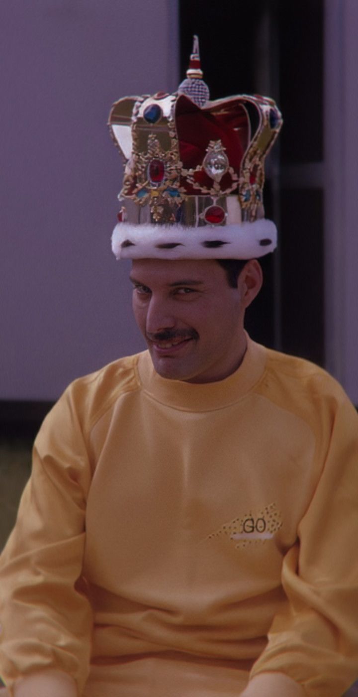 Freddie Mercury wearing a crown and a yellow shirt - 