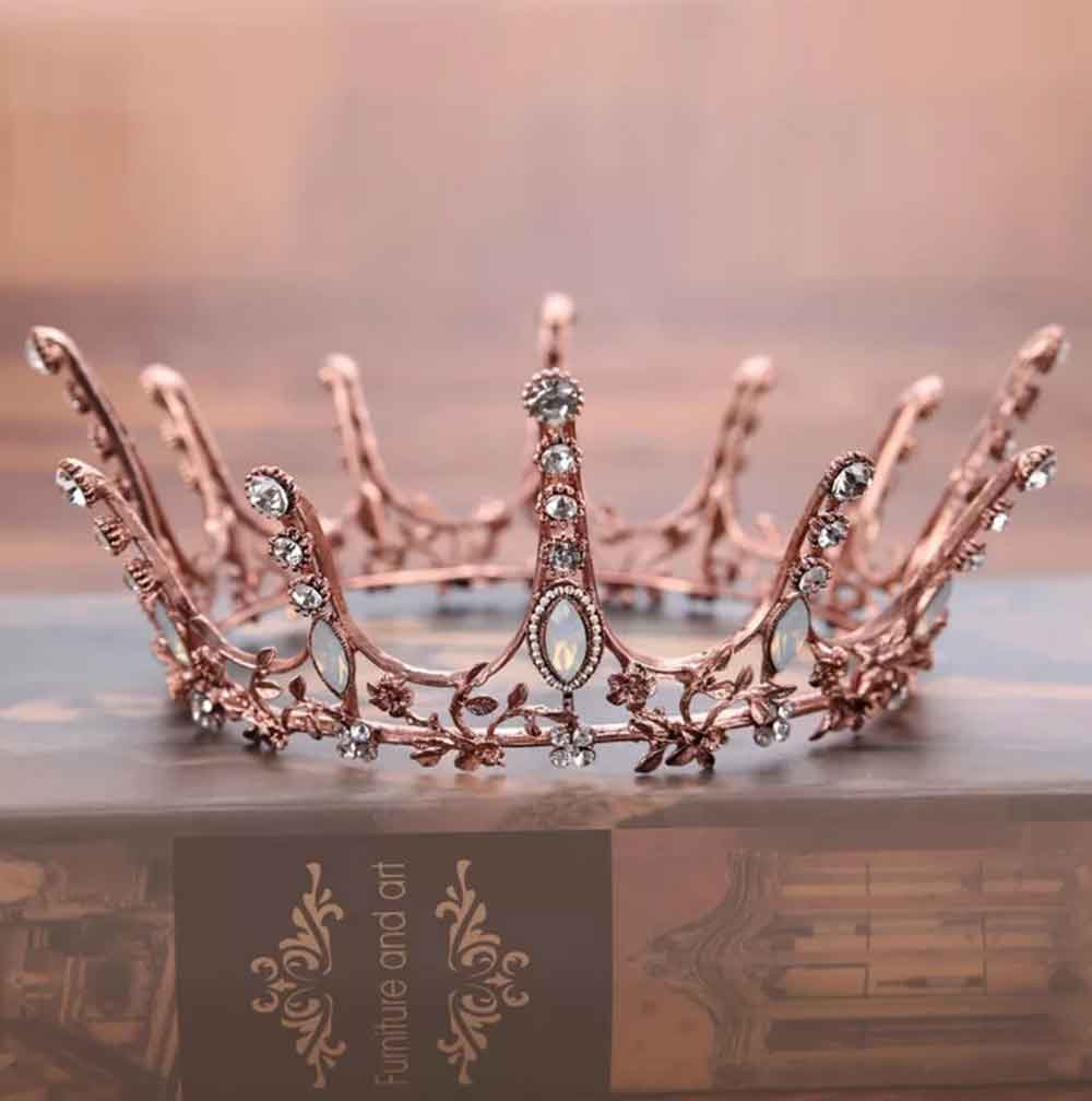 A rose gold crown with rhinestones on top - Royalcore