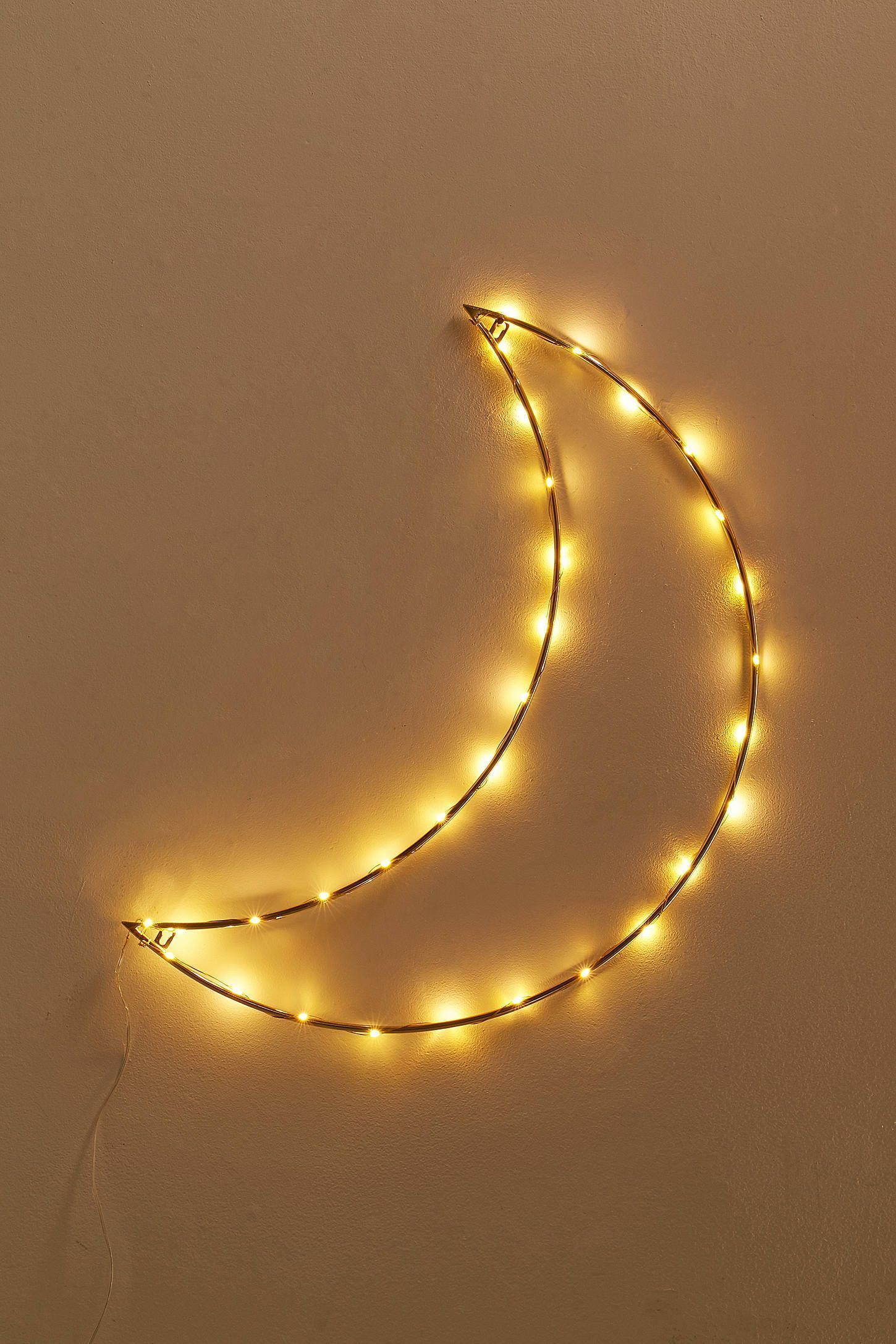 A moon-shaped string of lights on a wall. - Light yellow