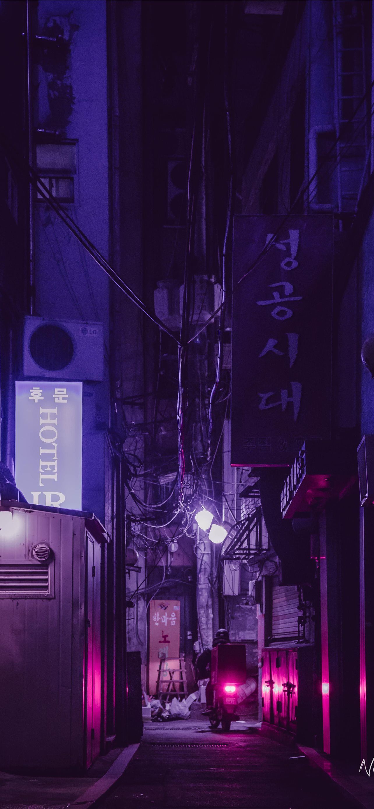 A dark alley with street lights and neon signs - Korean, Seoul