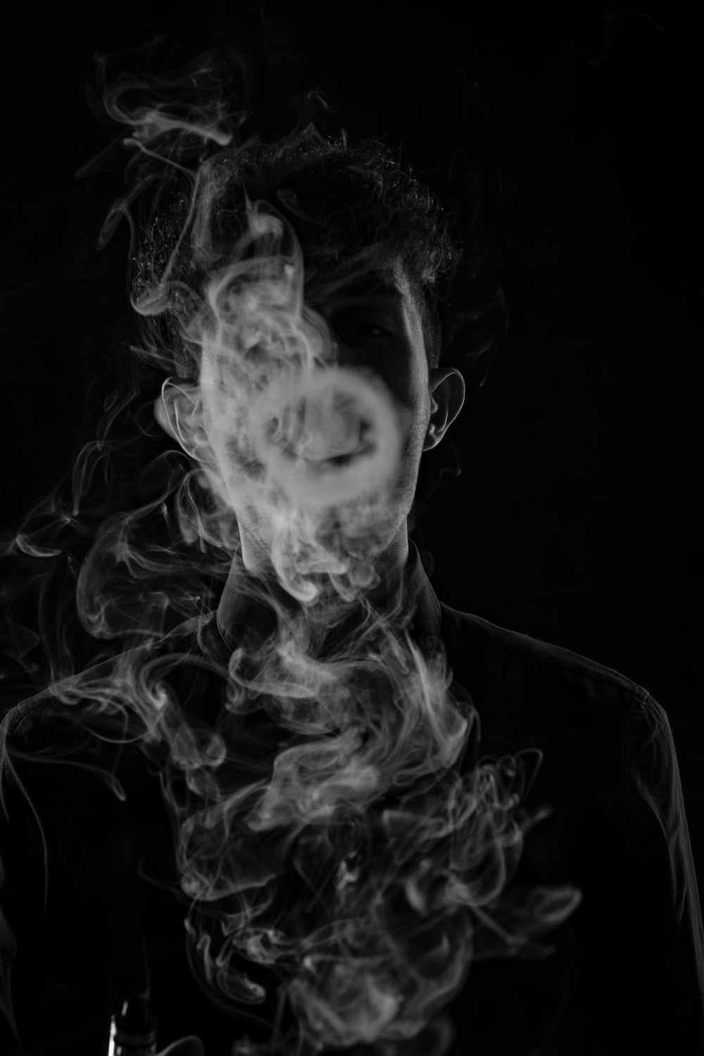 A man with his mouth open, exhaling smoke. - Depression