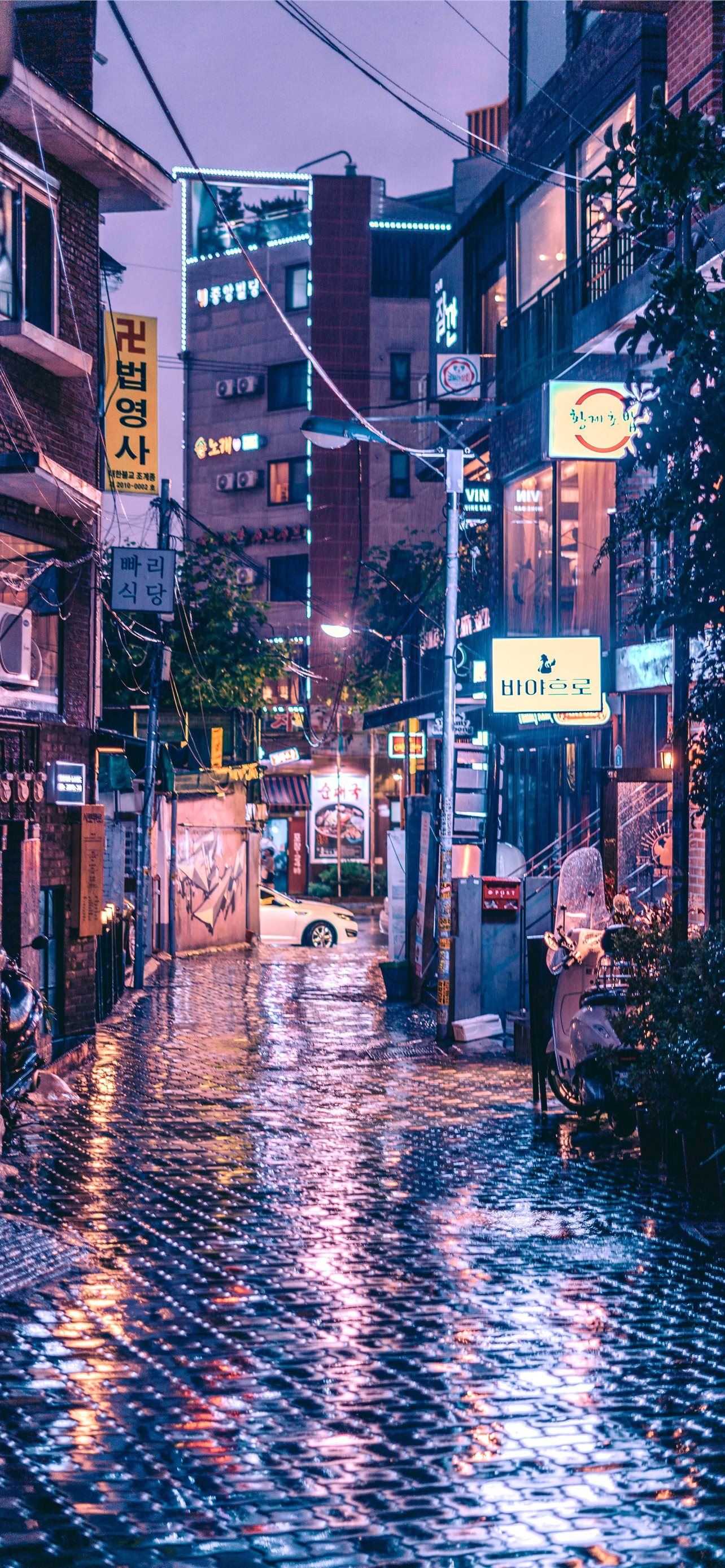 A city street with rain and buildings - Korean, Seoul