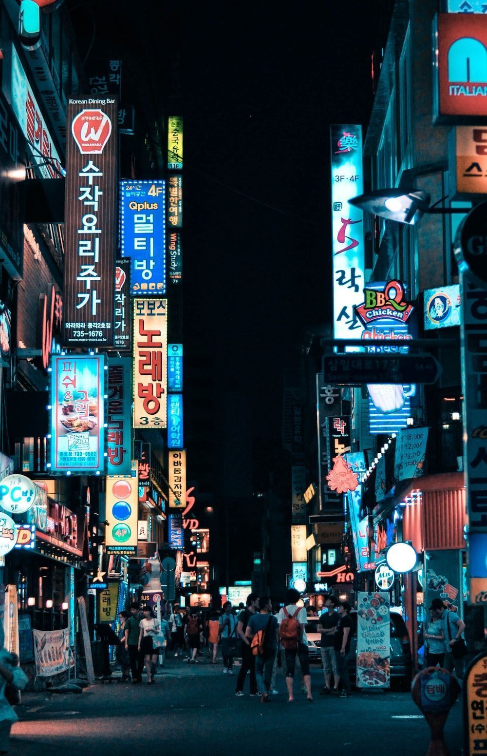 A city street with many neon signs - Korean, Seoul