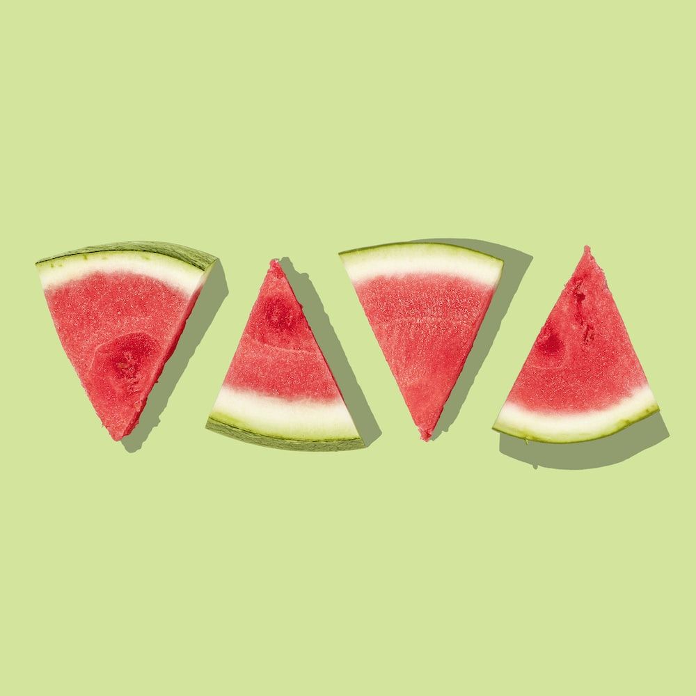 Four slices of watermelon on a green background - Watermelon