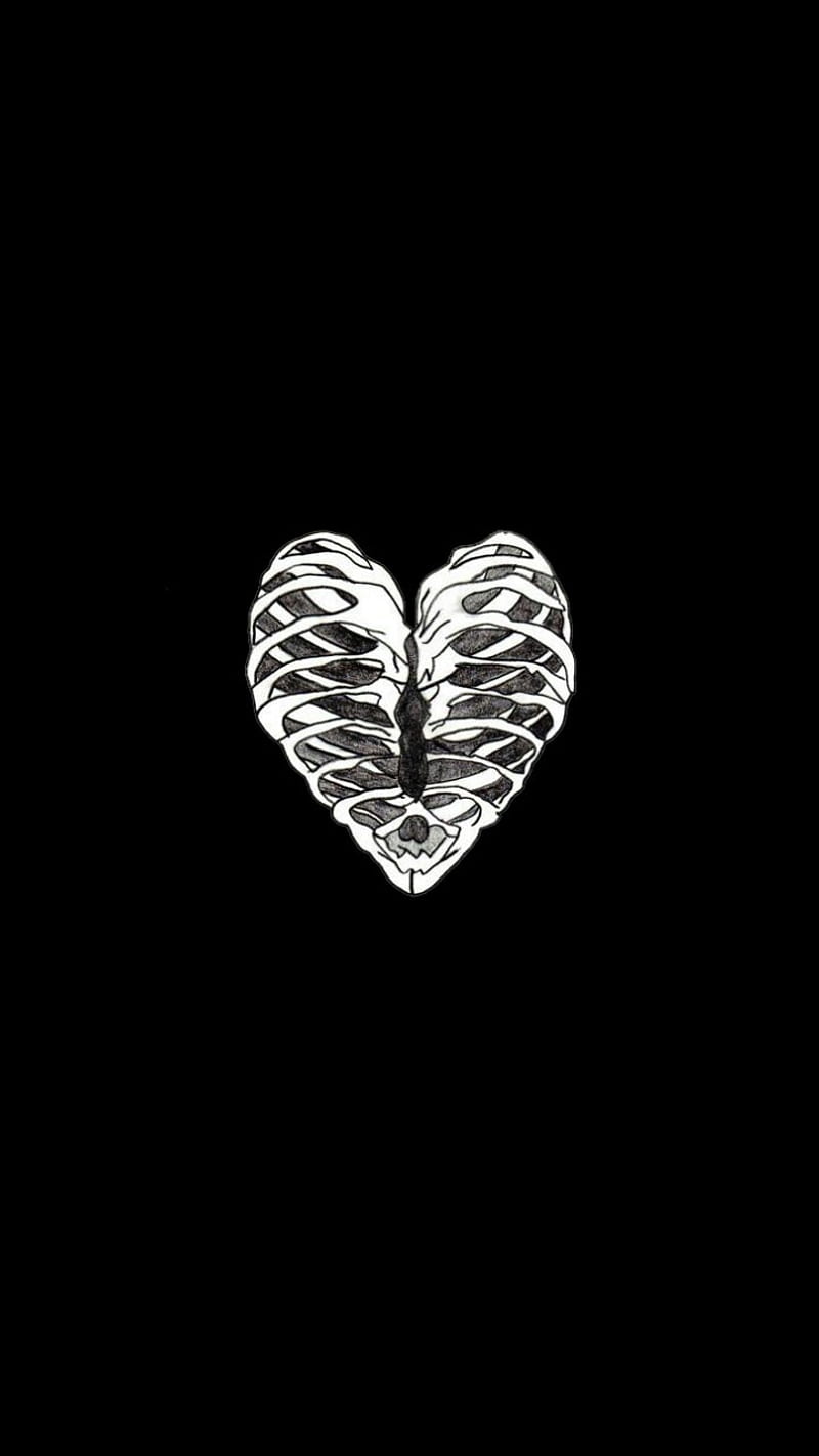 A silver heart shaped pendant on black background - Black heart