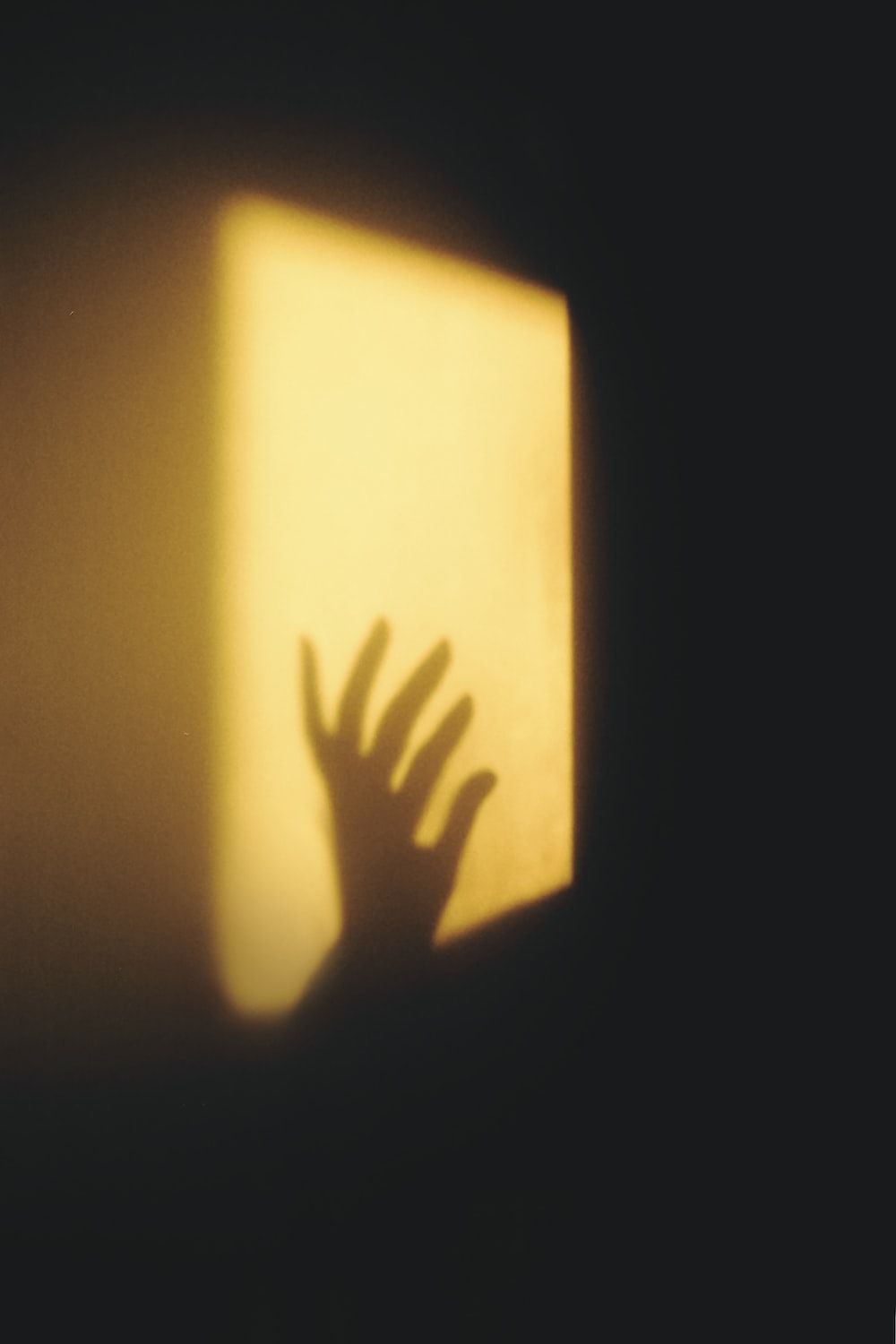 A shadow of a hand on a wall - Shadow