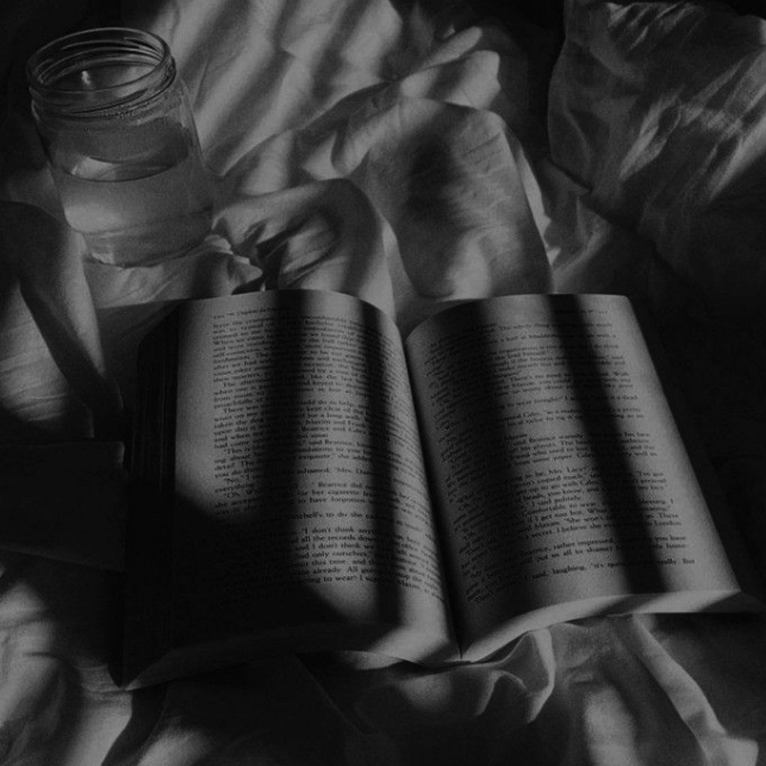 A book is open on top of some bed sheets - Shadow