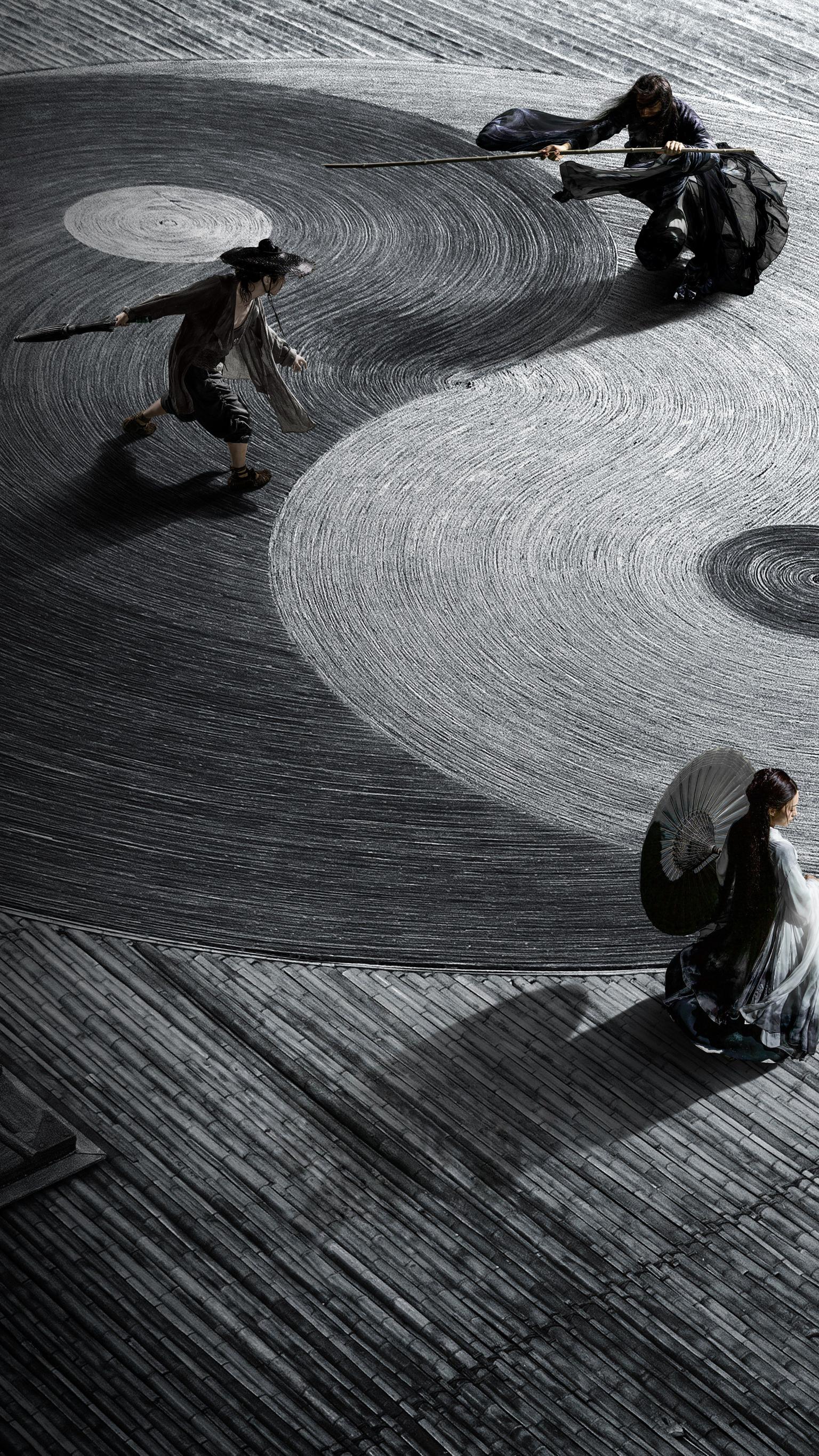 A black and white image of four performers on a stage. They are holding fans and wearing traditional Japanese clothing. - Shadow