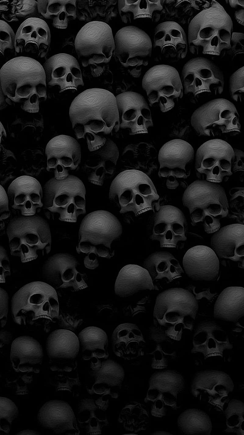 A large group of black skulls in the dark - Horror