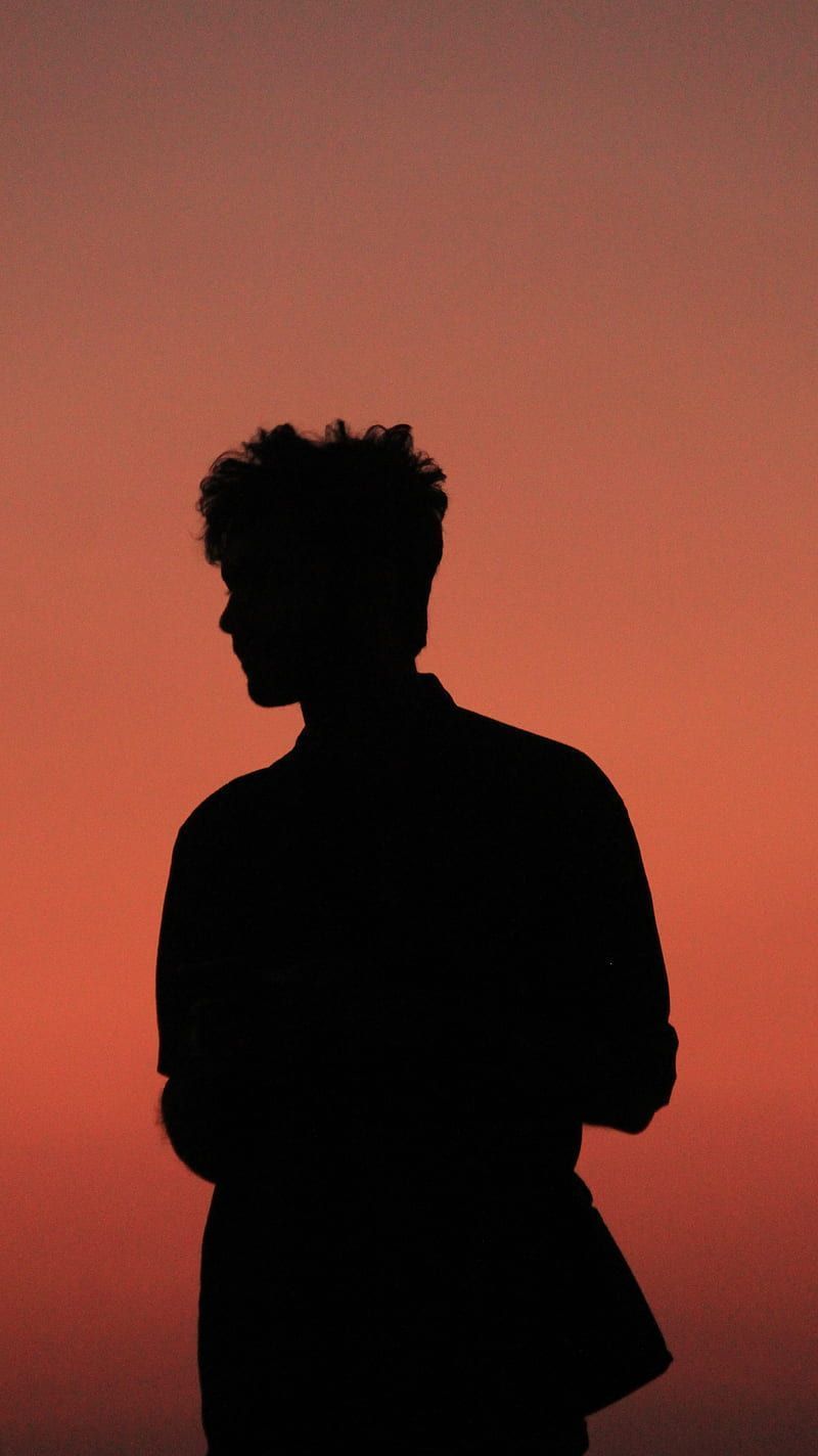 A silhouette of a man against a red sky - Shadow