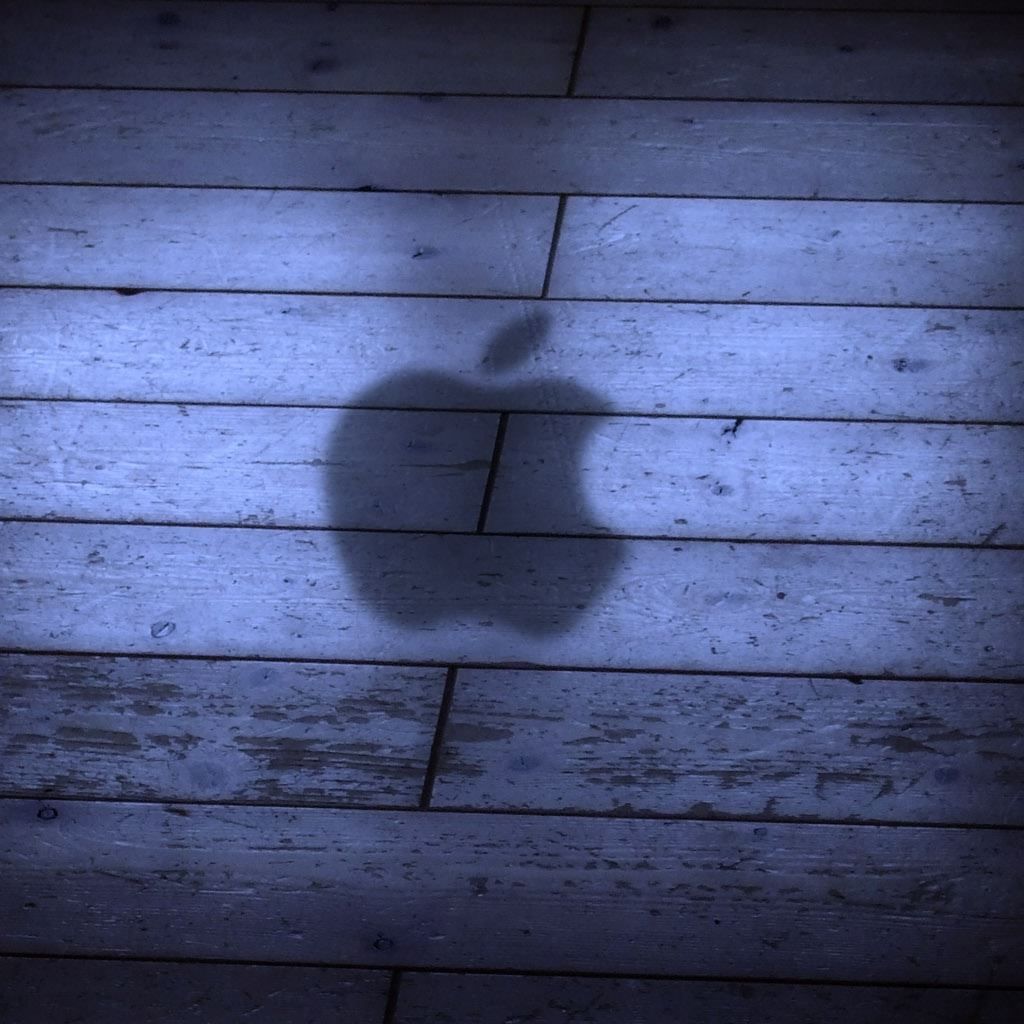 A shadow of an apple logo on the floor - Shadow