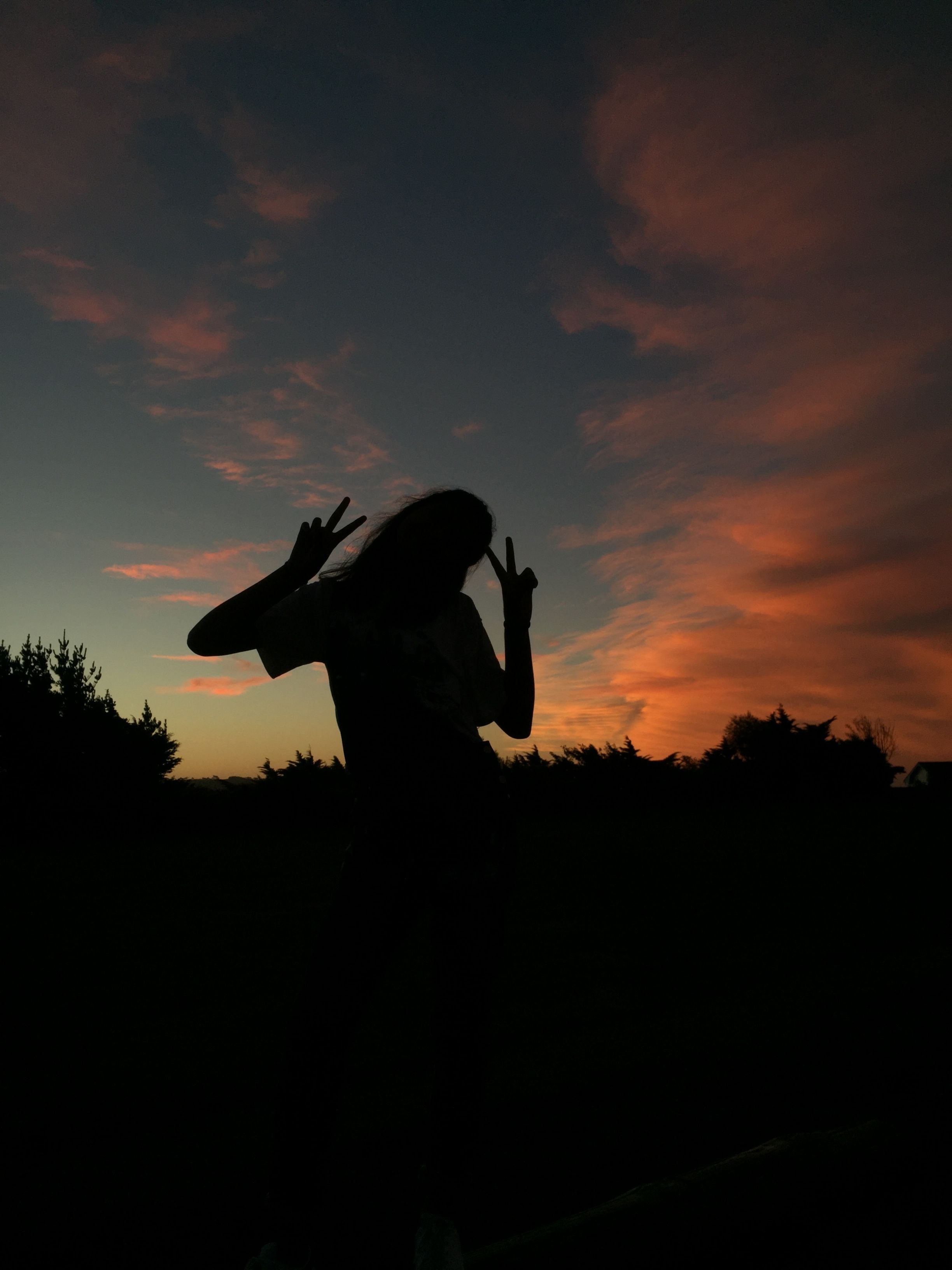 A woman is standing on top of the grass - Shadow