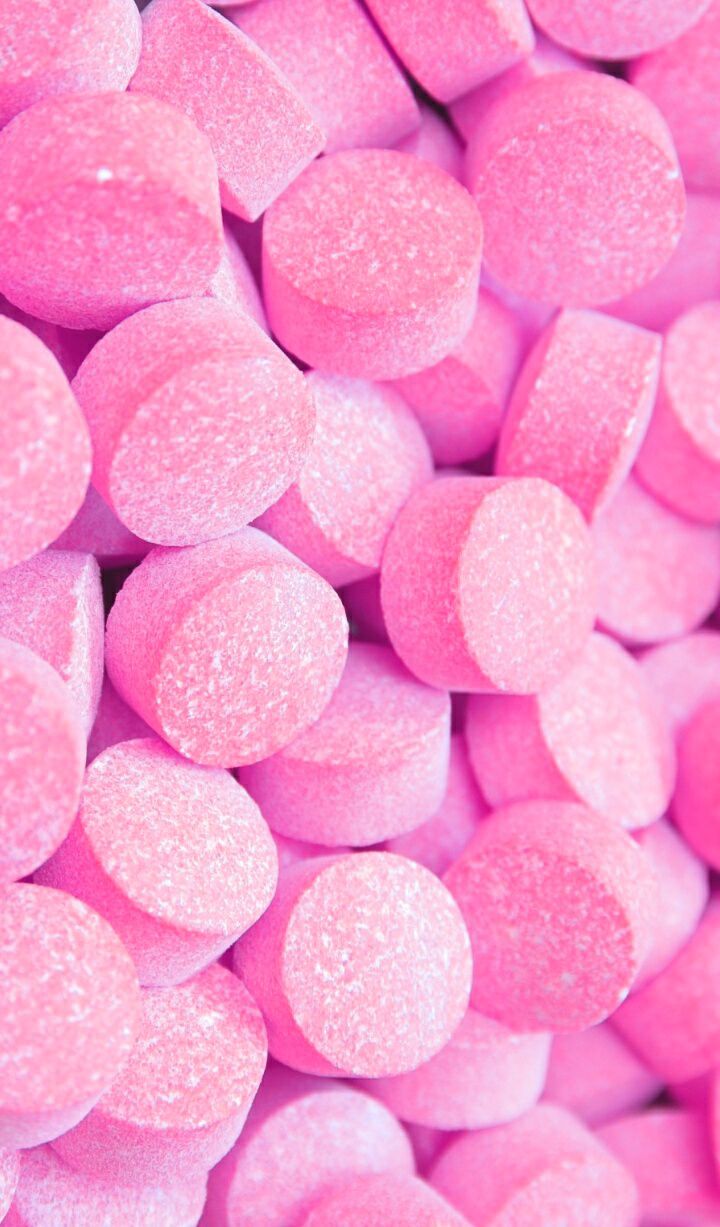 A close up of pink candy in the shape - Candy