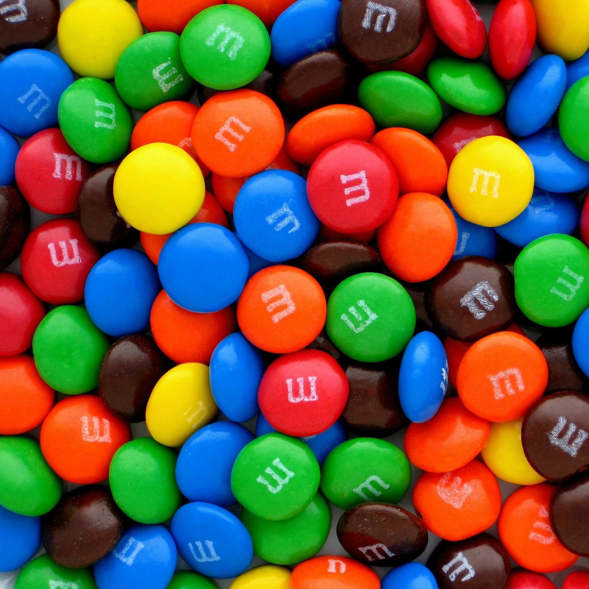 A pile of colorful M&M's chocolate candy. - Candy