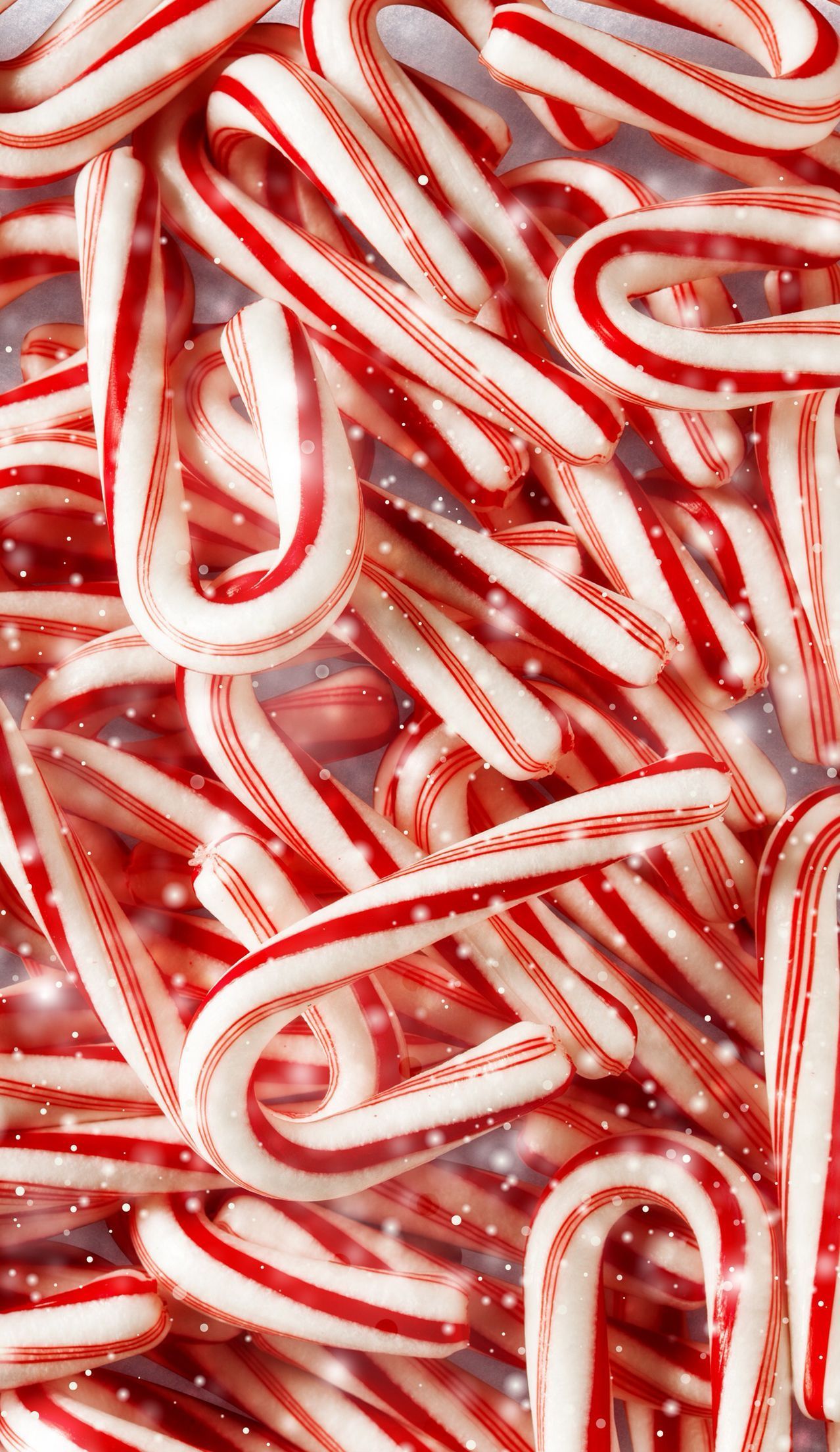 A close up of candy canes in a pile - Candy, candy cane