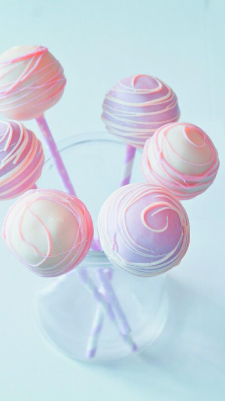 A glass bowl with some cake pops in it - Candy