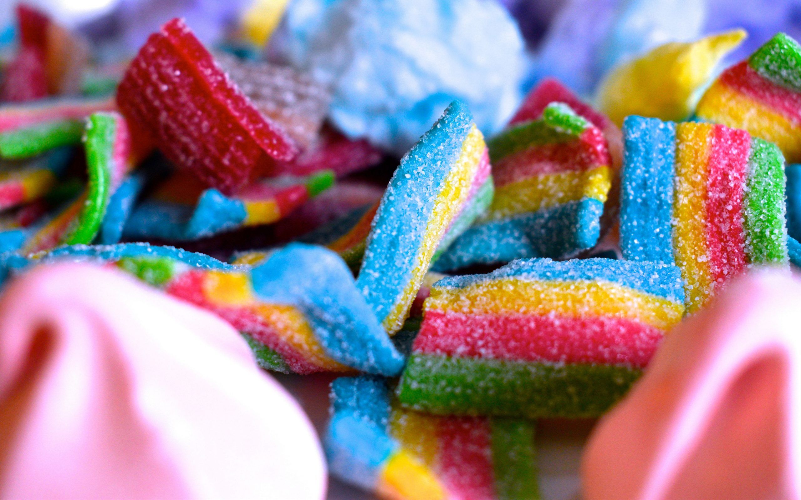 A pile of colorful gummy worms. - Candy