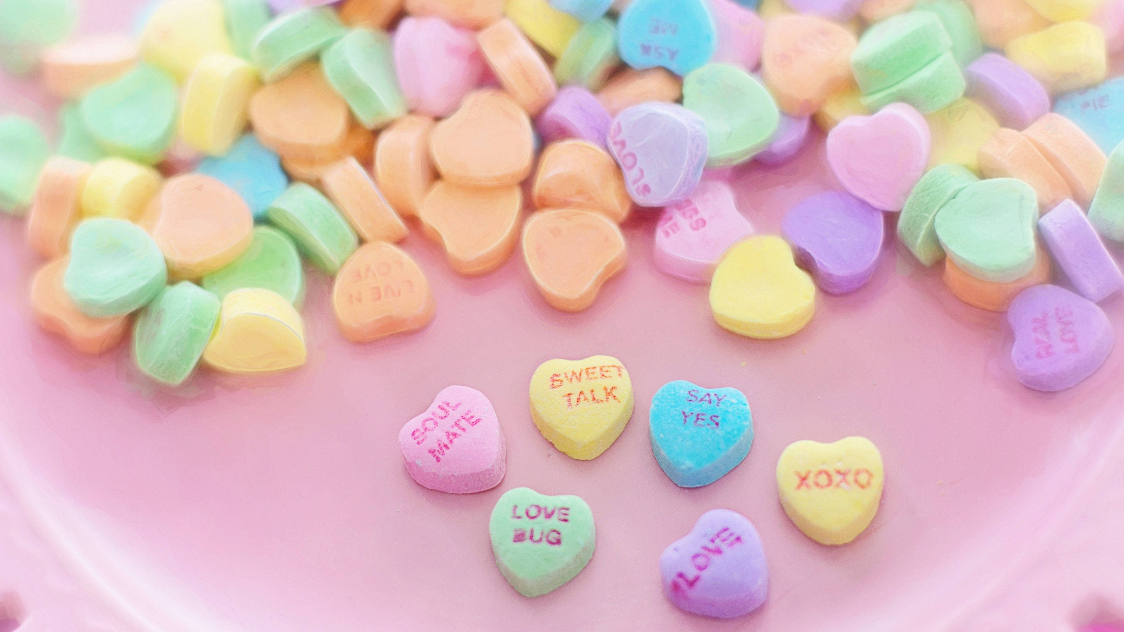 Conversation hearts on a pink background - Candy