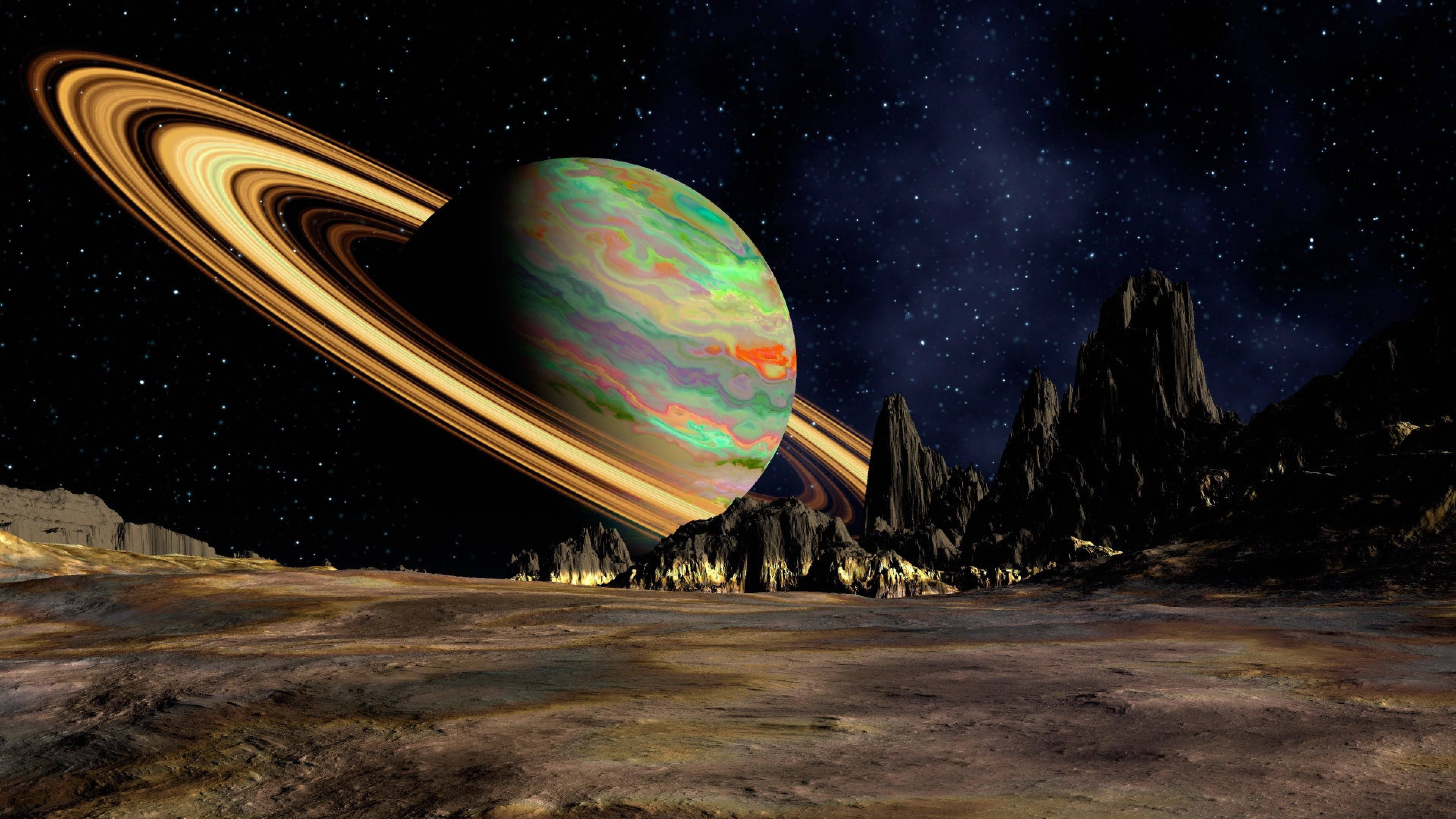 A gas giant planet with a ring system orbits a rocky planet. - Saturn