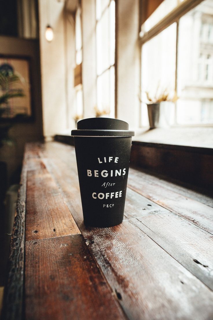 A black coffee cup with the words Life Begins After Coffee written on it. - Coffee