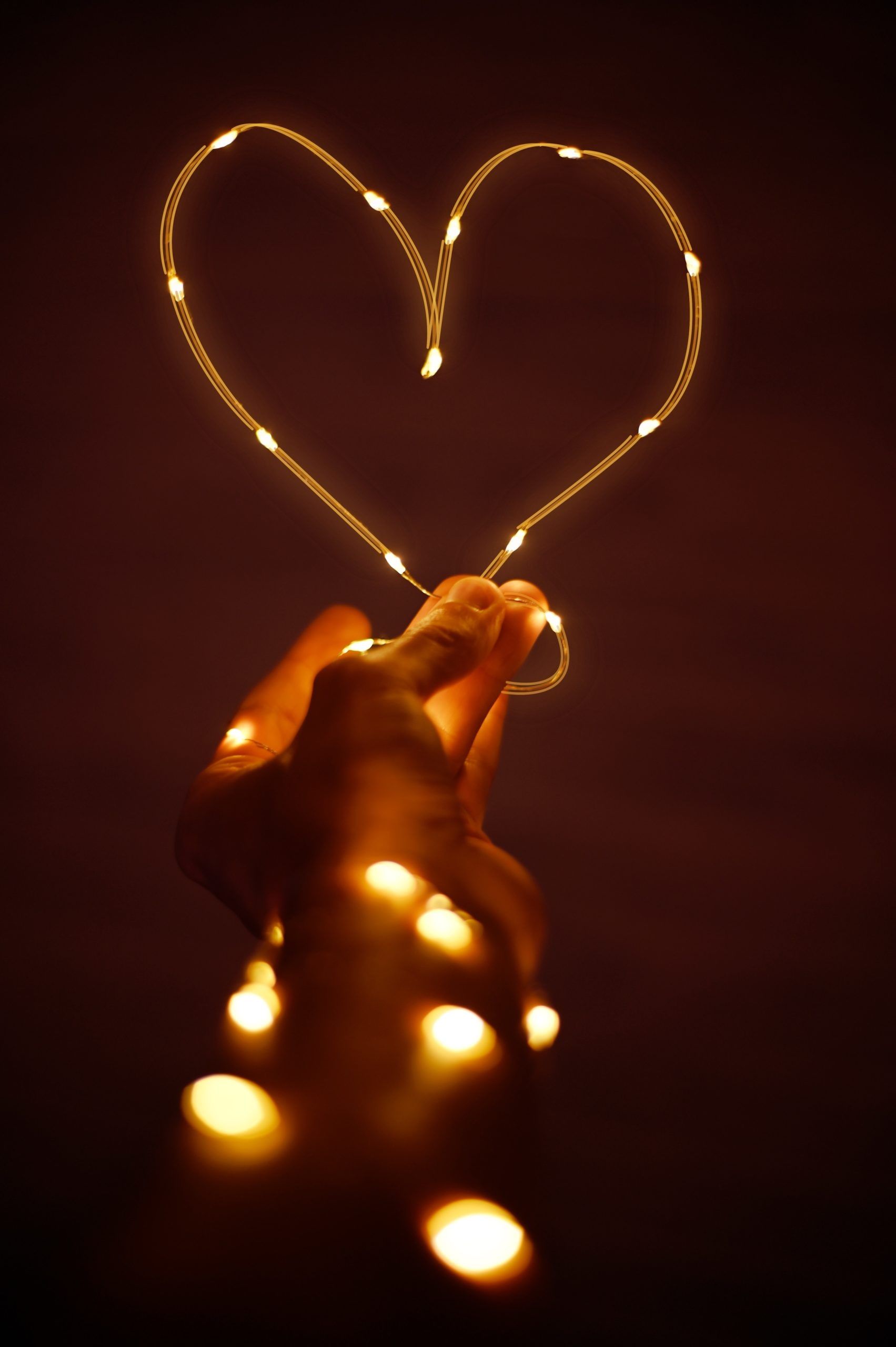 A heart made out of lights in a persons hand - Heart