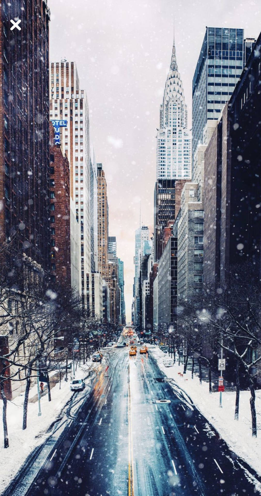 A snowy street with cars driving down it - New York