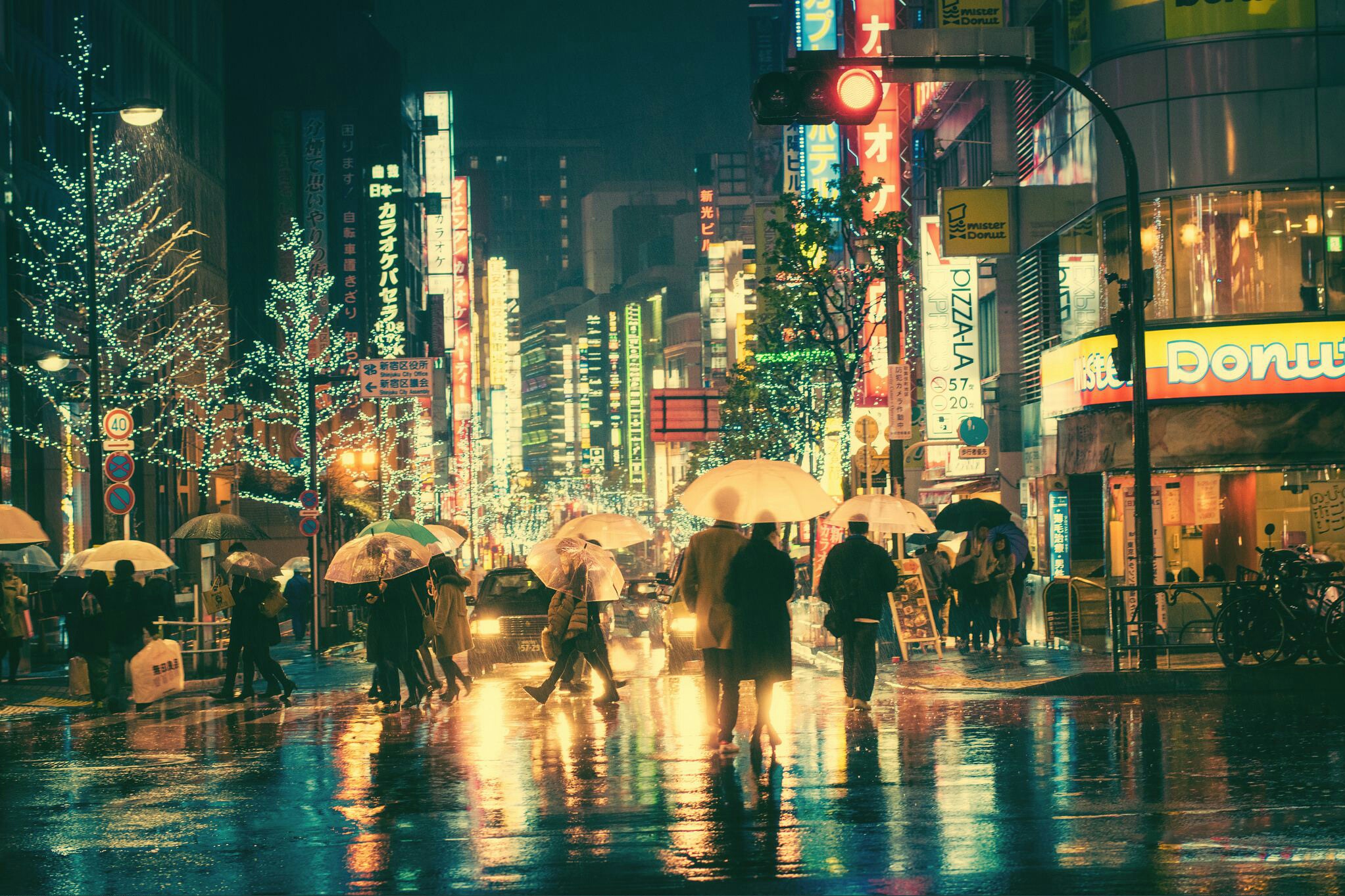 A group of people walking down the street holding umbrellas - Tokyo