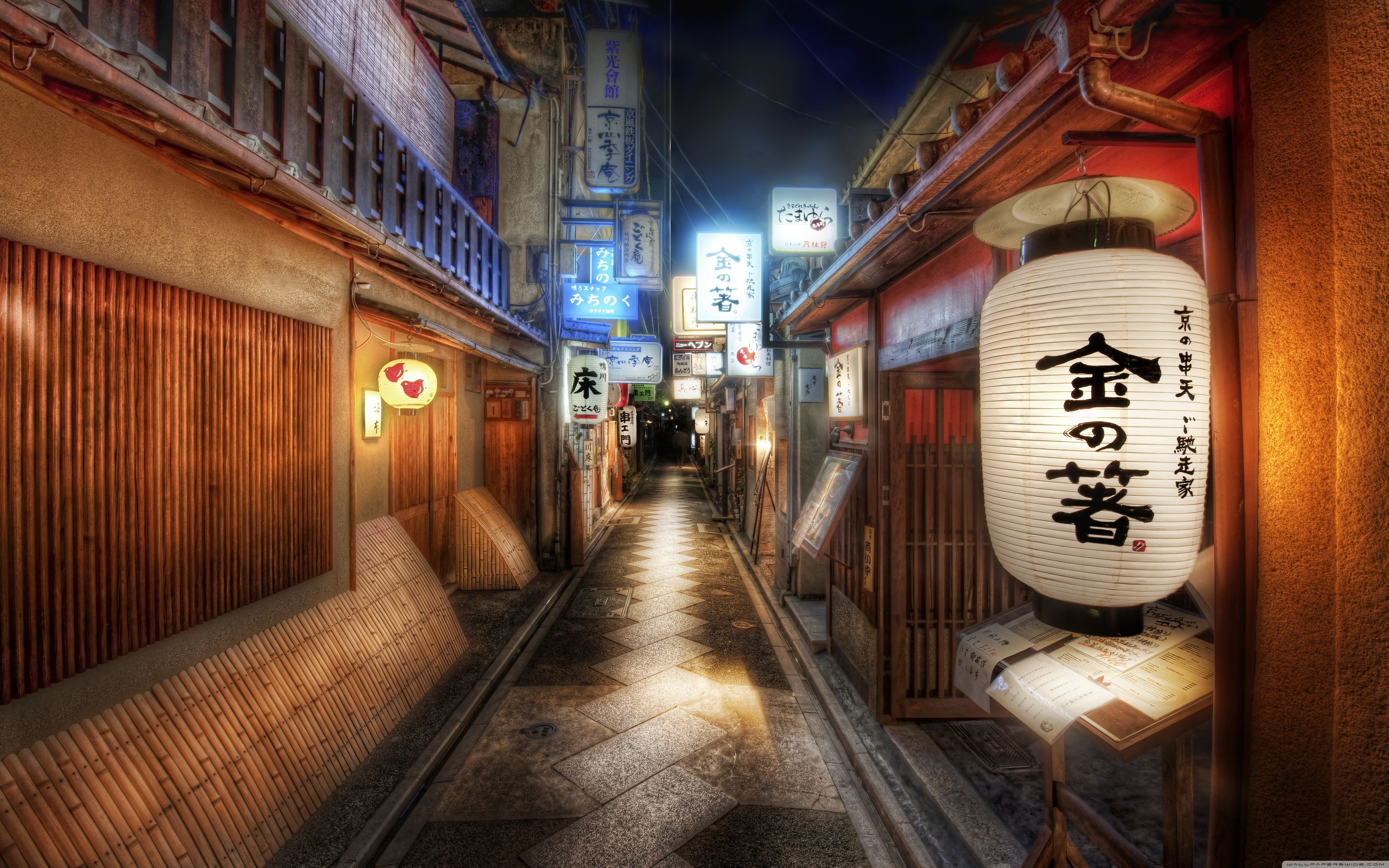 A lantern hanging from a wall in a Japanese alleyway - Japan