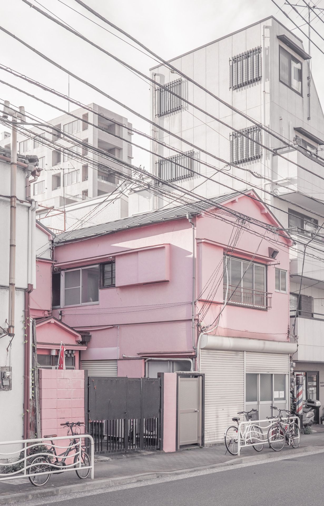 A pink building with bikes parked in front of it - Japan, Seoul