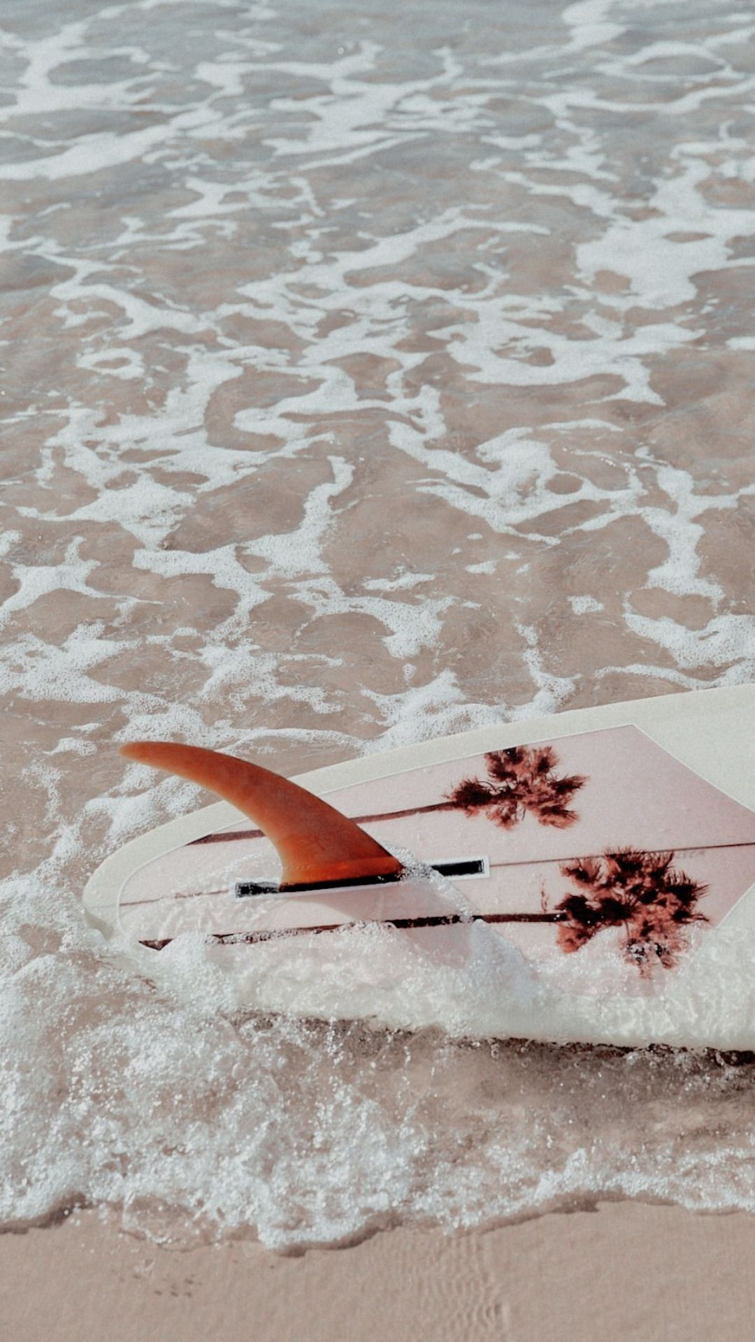 A surfboard is floating in the water - Beach