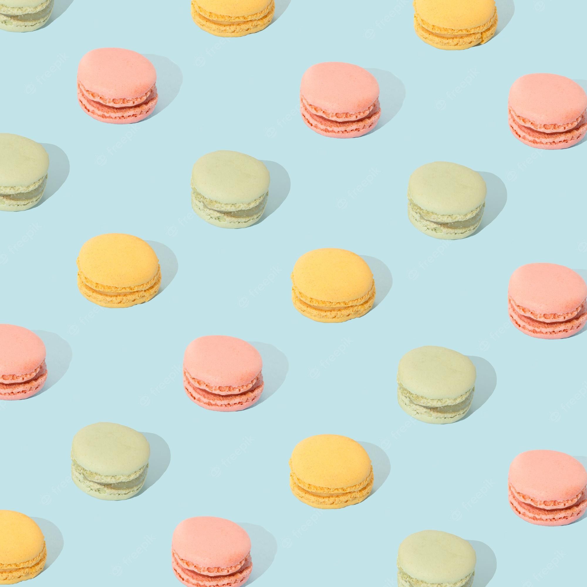 Premium Photo. Sweet food macarons on a blue background colorful aesthetic layout