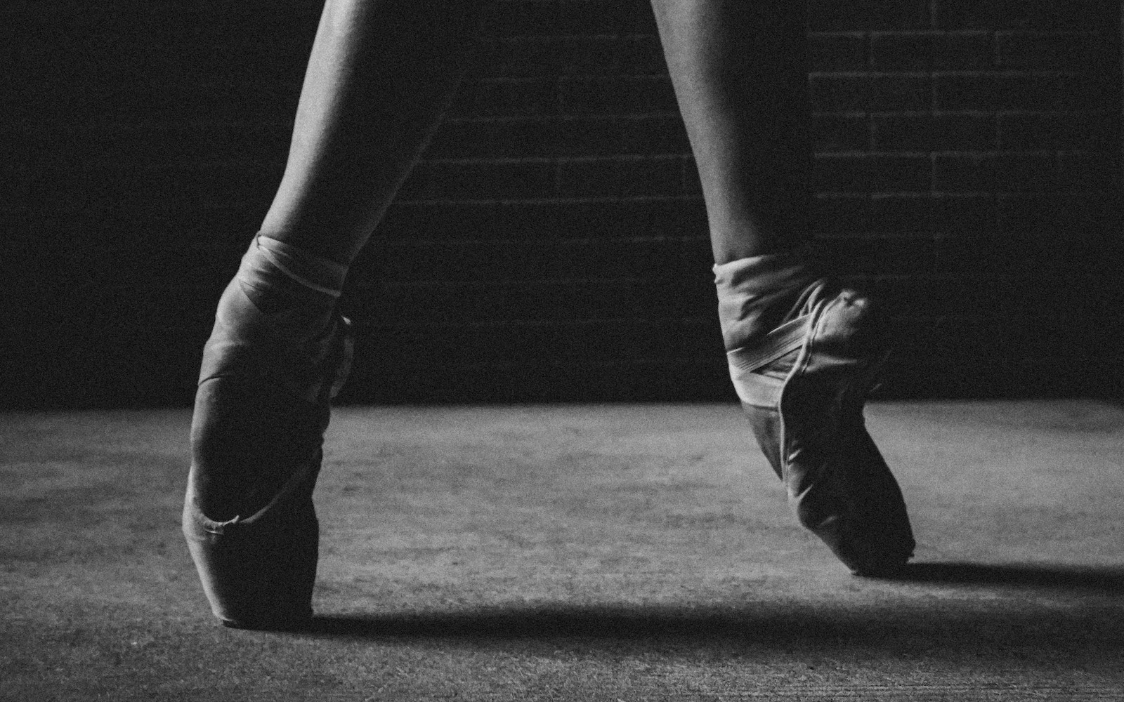 A black and white photo of a ballerina's feet in pointe shoes. - Dance, ballet, shoes