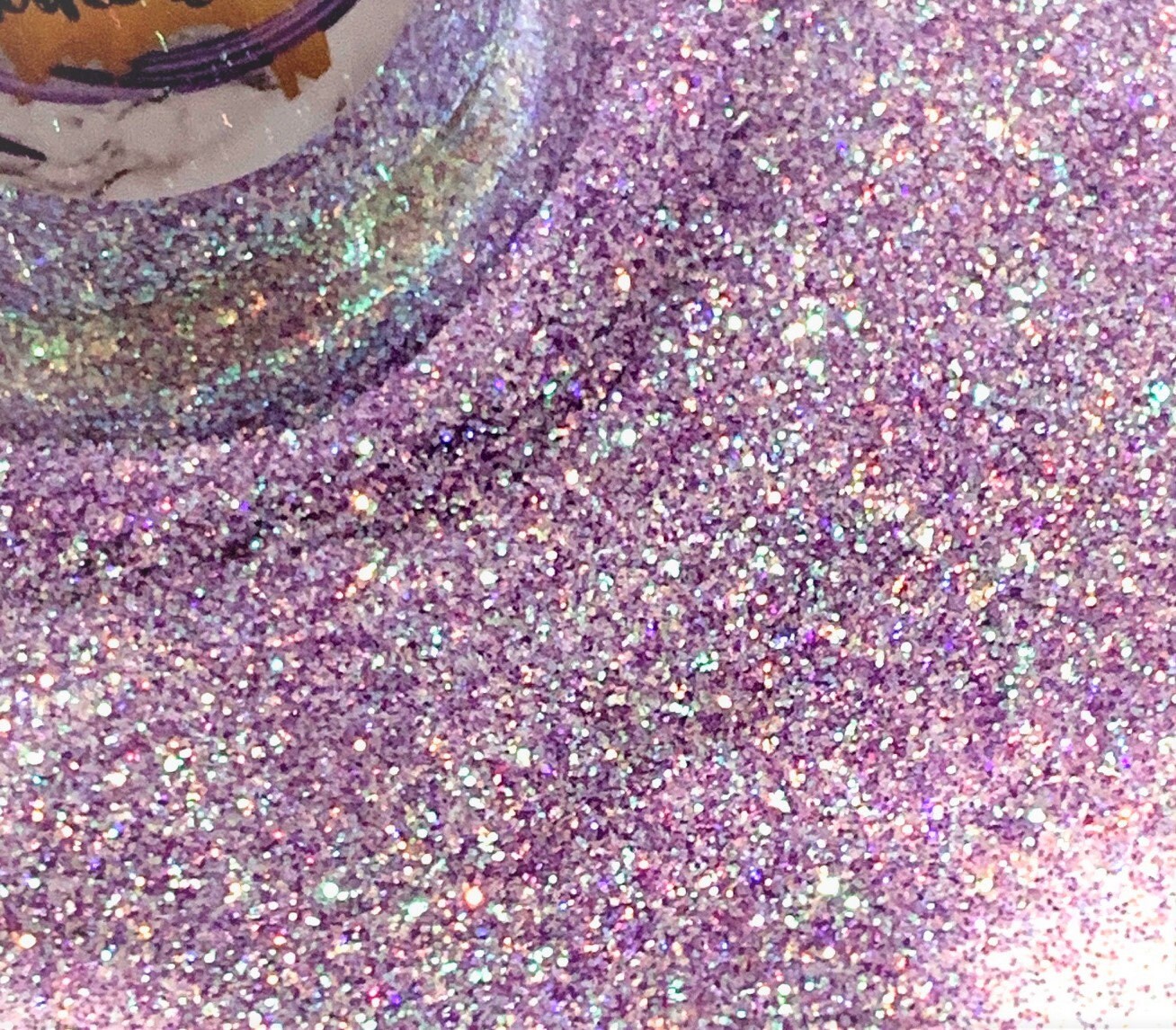 A close up of a purple glittery substance in a jar - Diamond