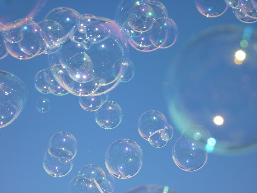 Bubbles floating in the air with a blue background - Bubbles