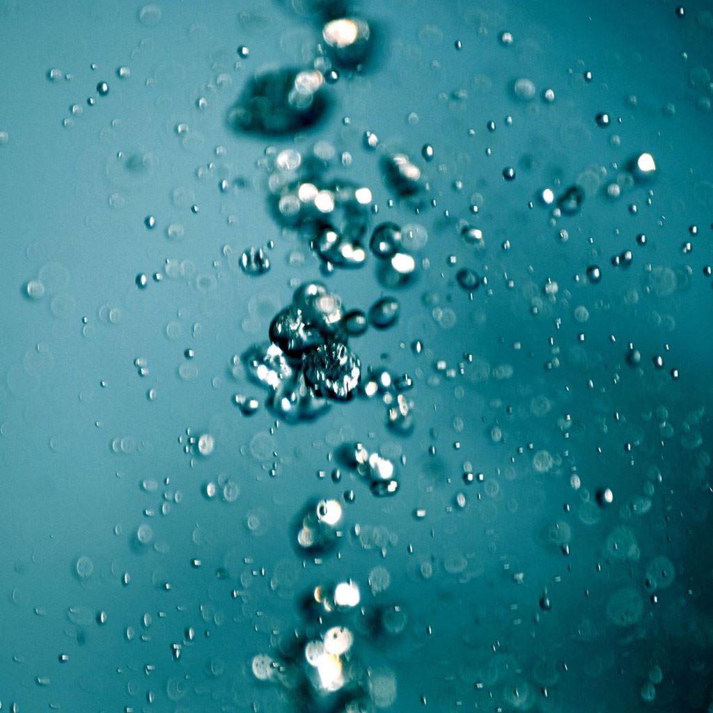A close up of water droplets in the air - Bubbles