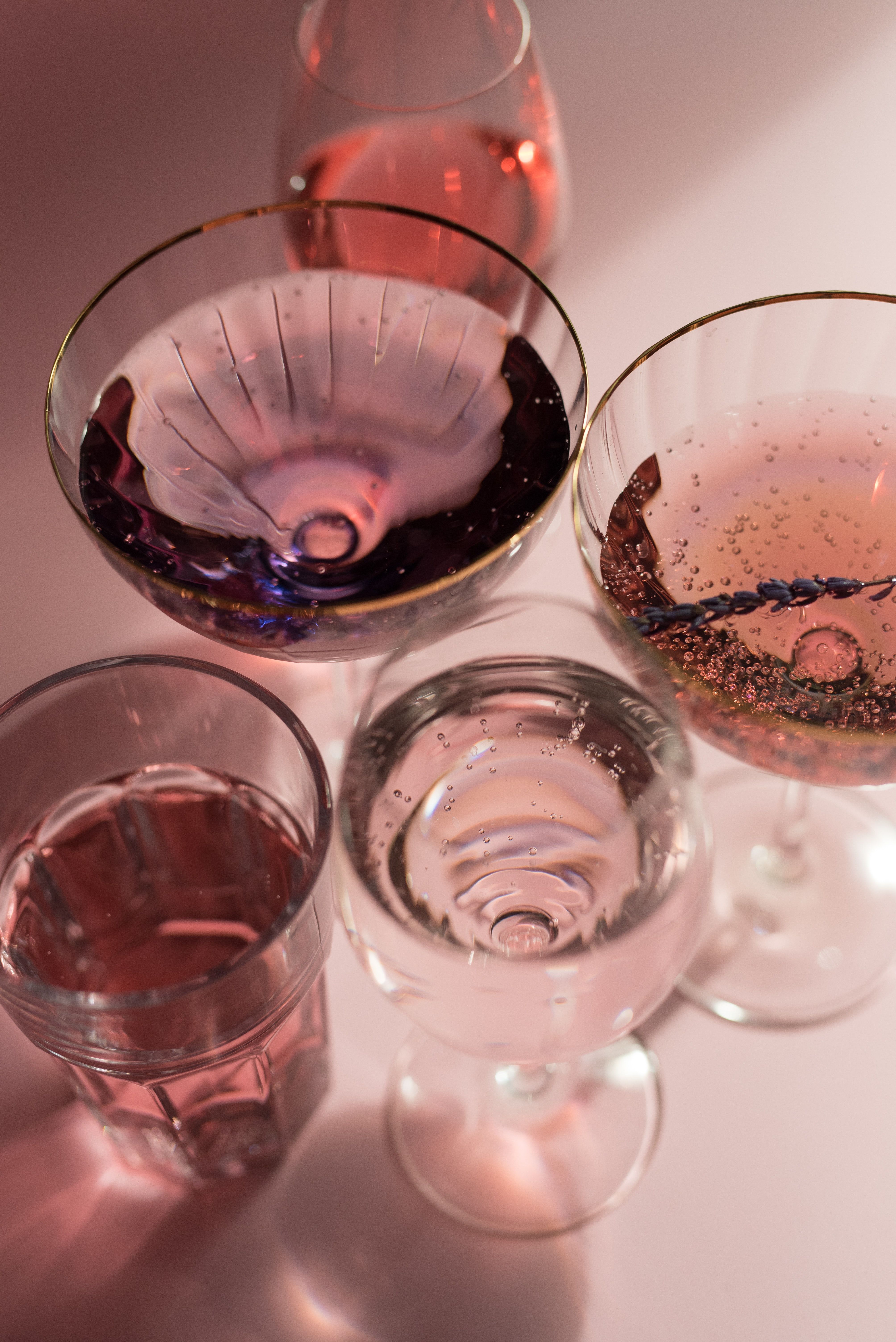 A group of glasses with different colored drinks - Champagne