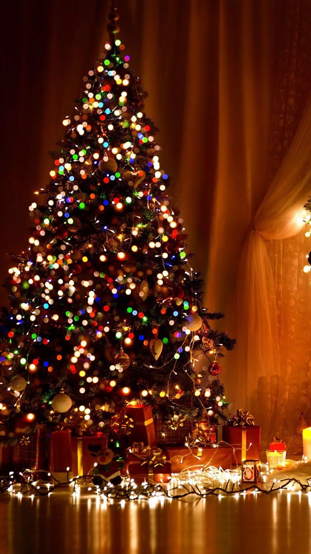 A Christmas tree with lights and presents underneath. - Christmas lights