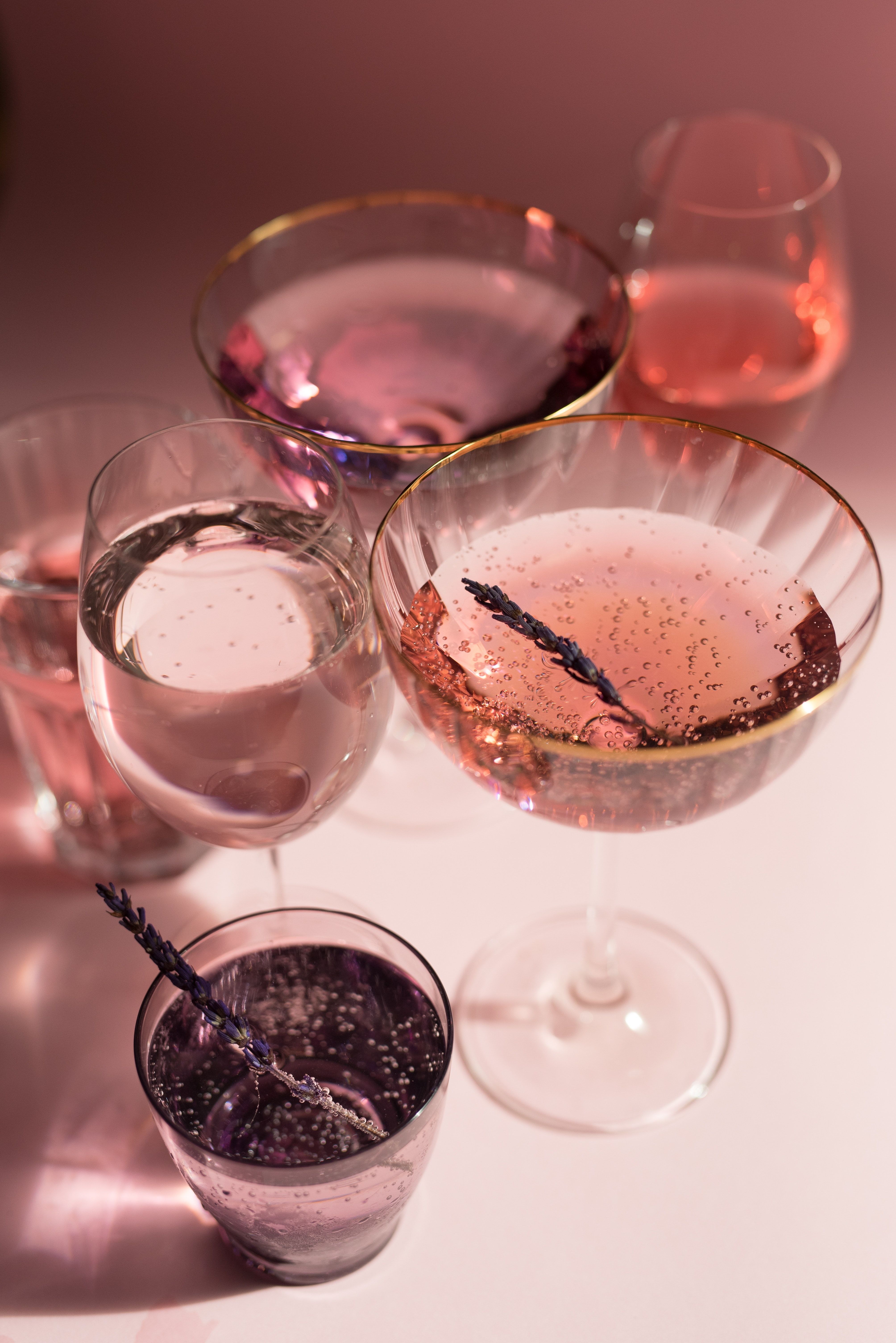 A group of glasses with different colored drinks - Champagne