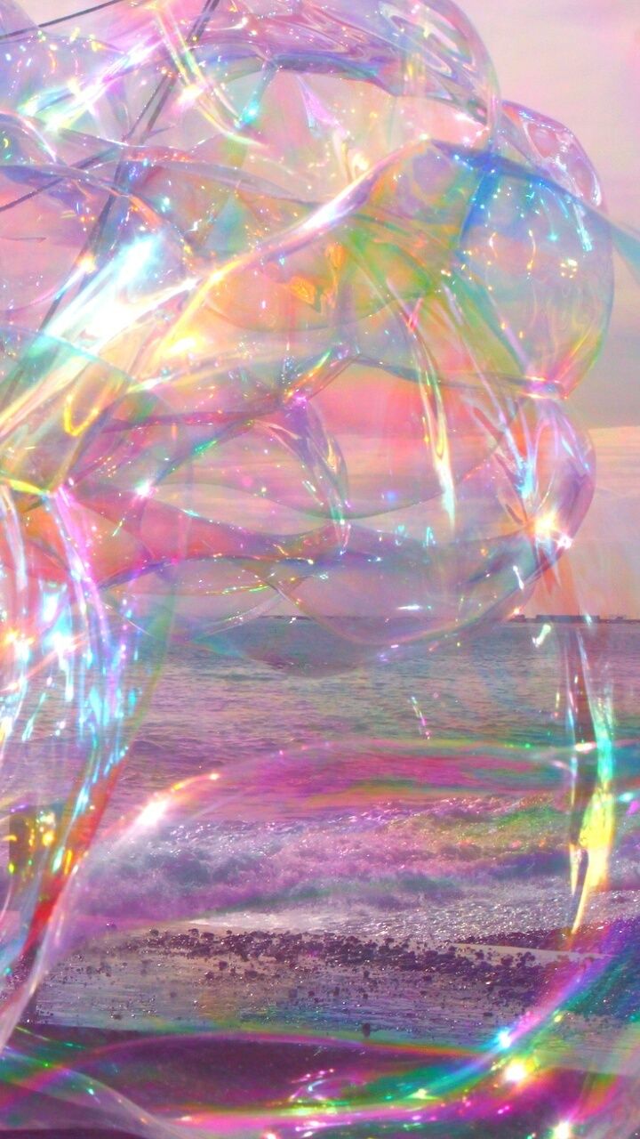 A bubble filled with rainbow colors floating in the air. - Bubbles