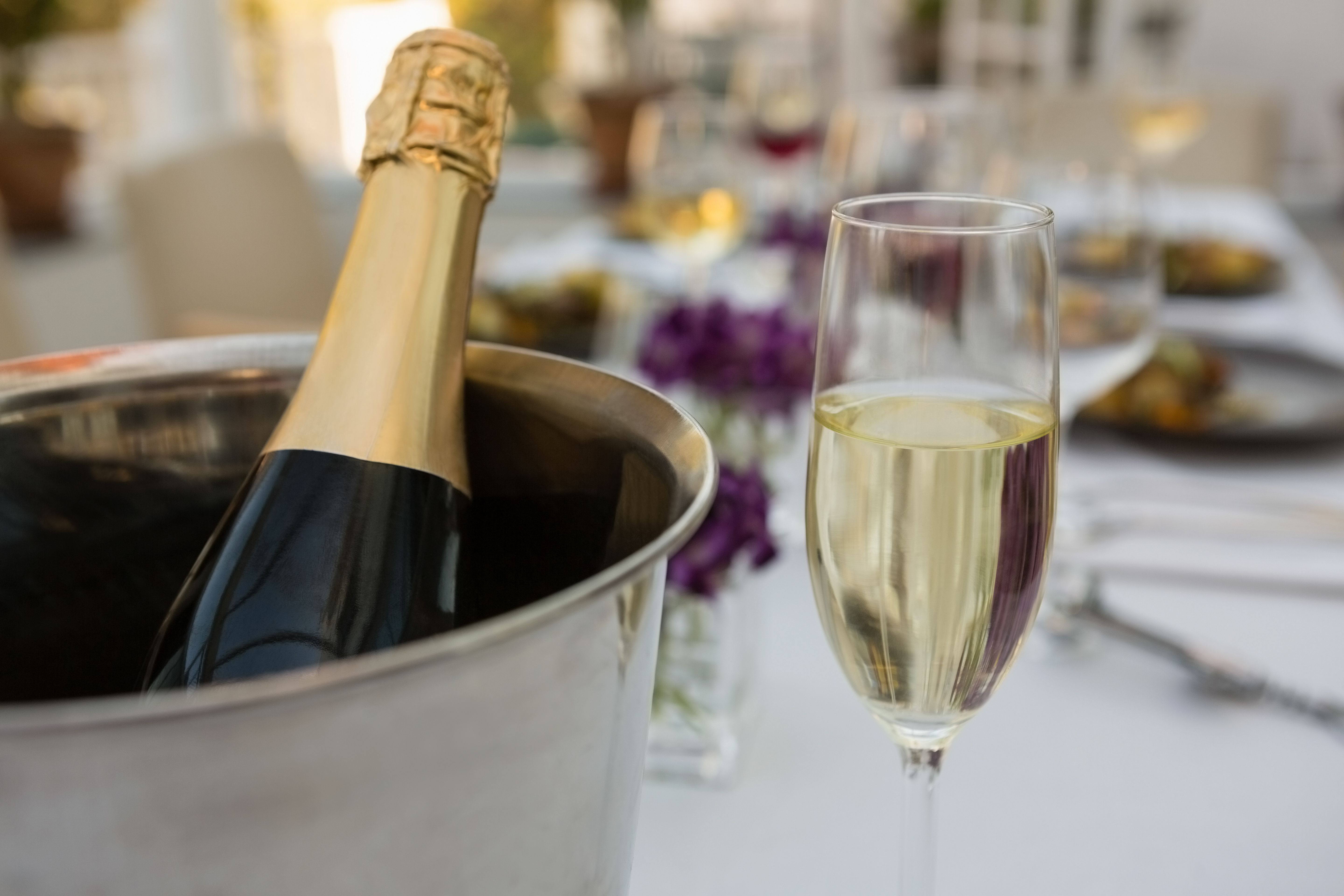 Champagne bottle in bucket with glass on table in restaurant Photo from PikWizard