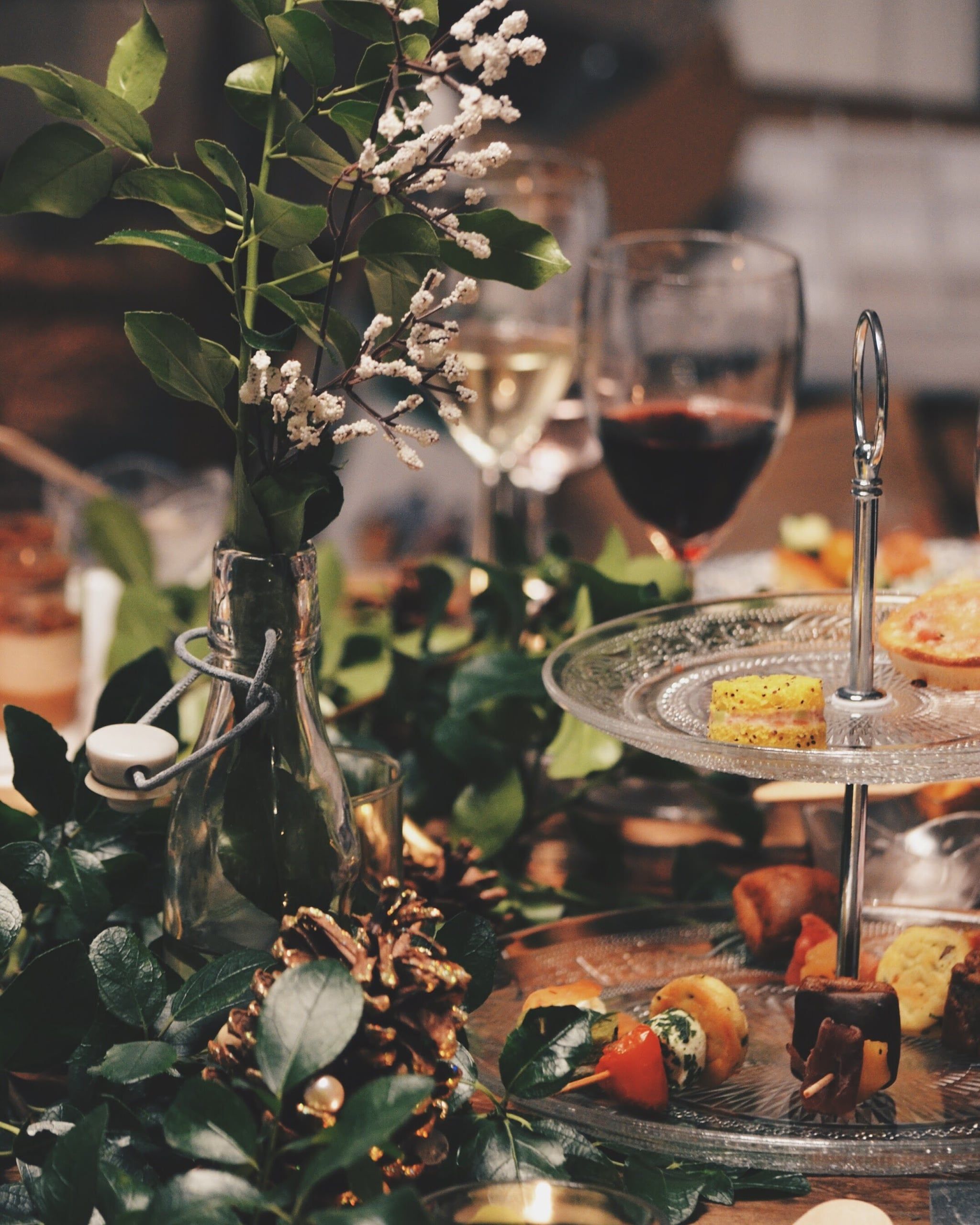 A table set with plates of food and glasses of wine. - Champagne